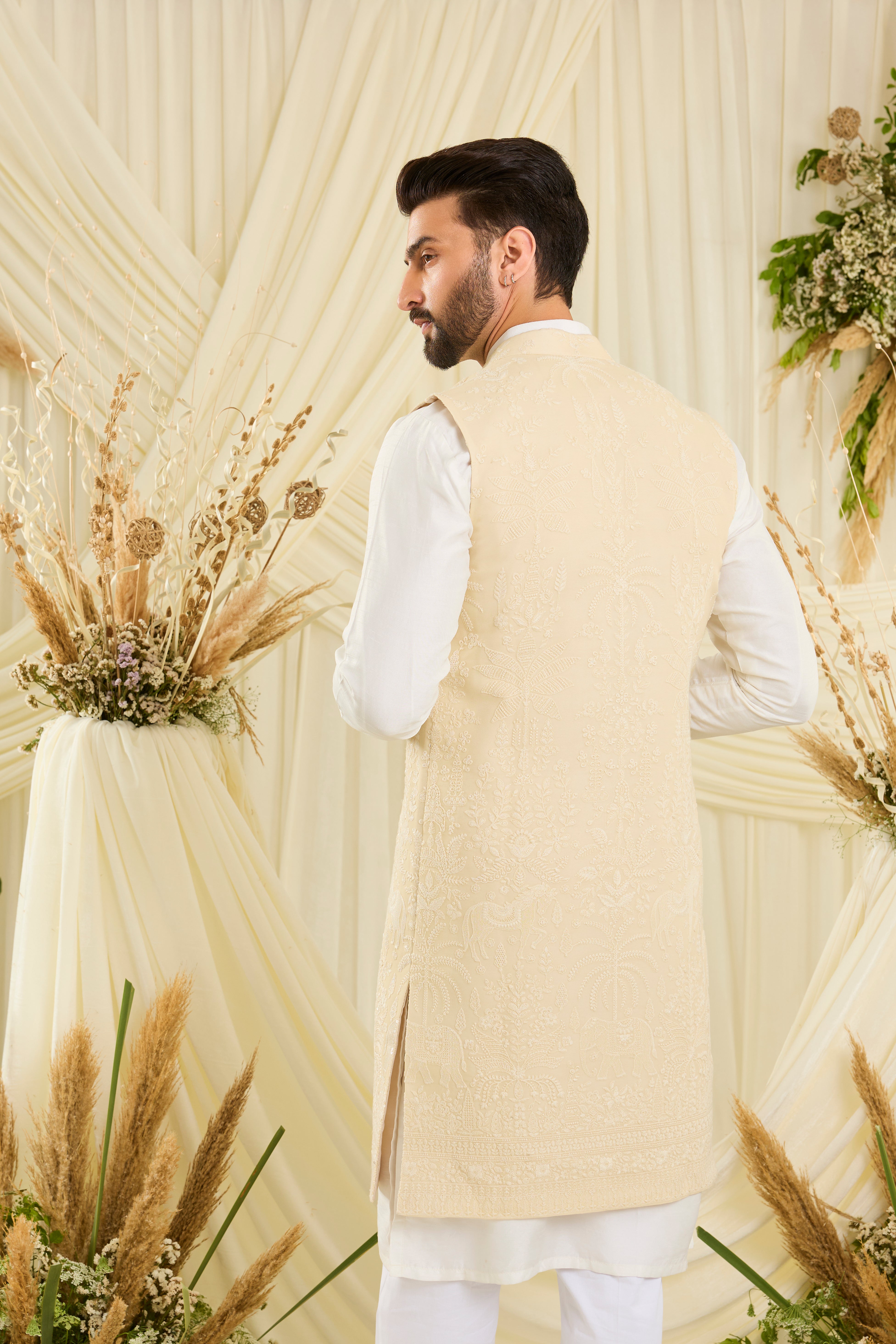 Yellow chikankari long jacket with ivory threadwork, flora-fauna embroidery, and delicate sequins for a refined, luminous couture statement.