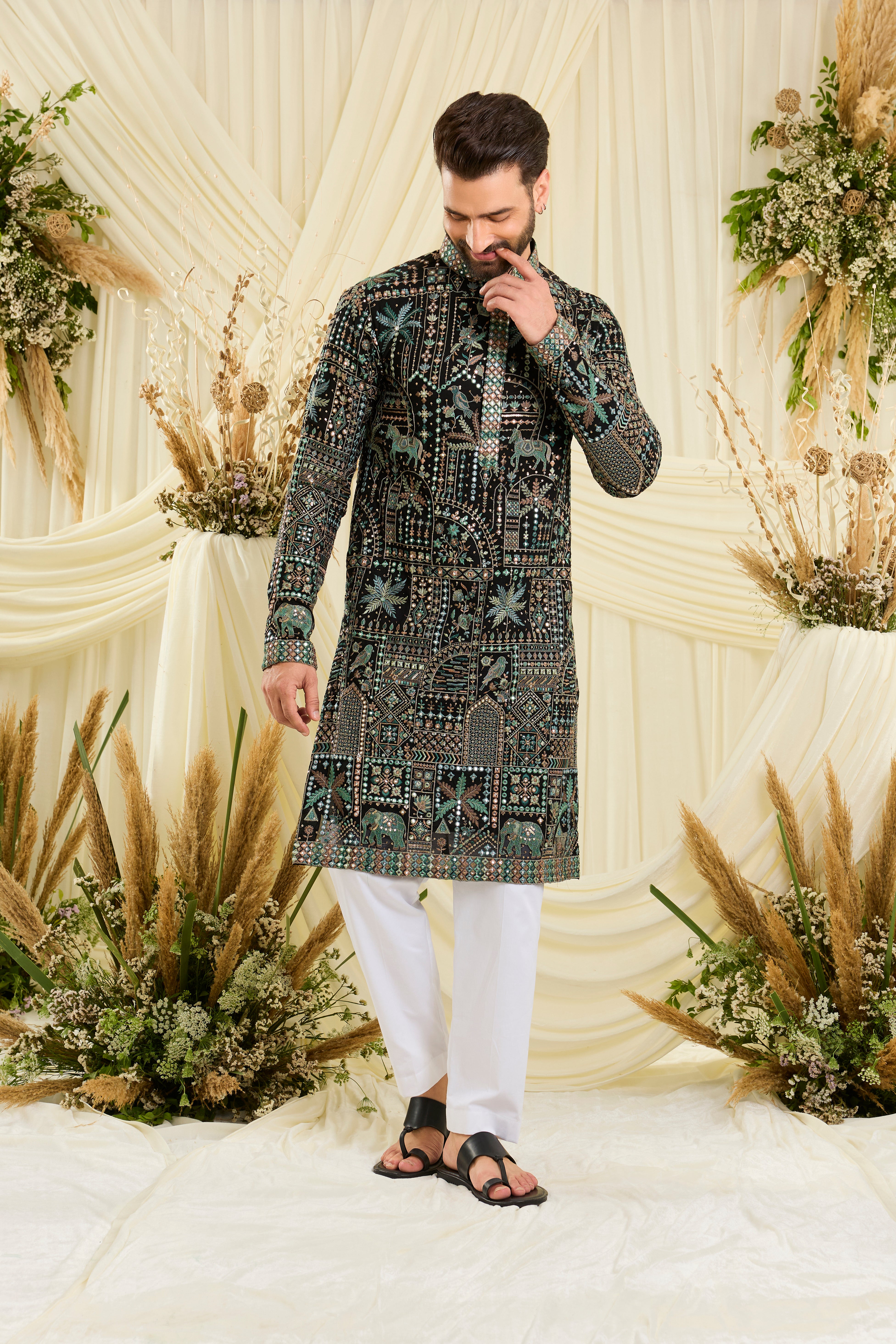 Black kurta with flora-fauna embroidery, multicolour threadwork, and mirror-like sequins — bold, luminous, and effortlessly luxurious.