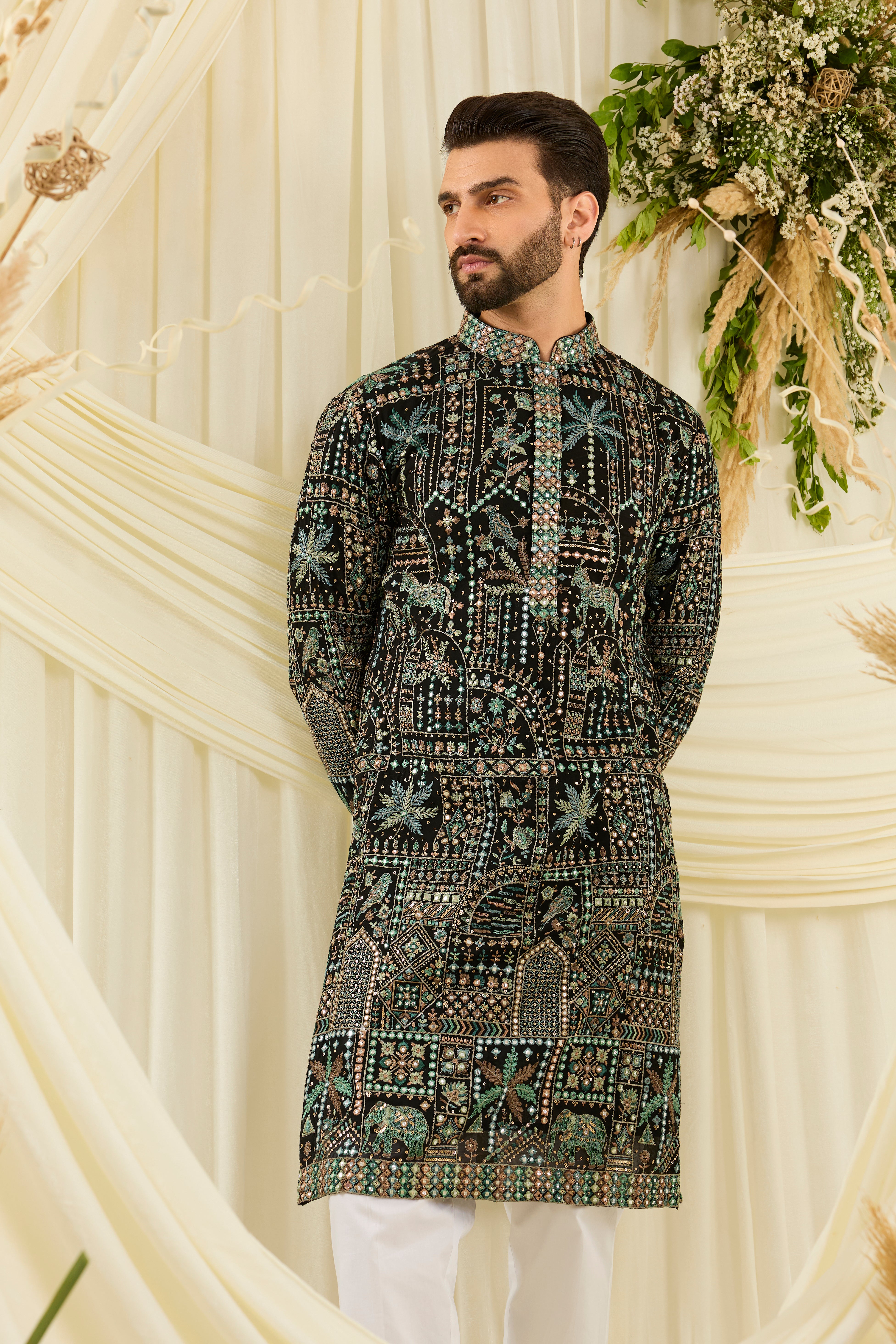 Black kurta with flora-fauna embroidery, multicolour threadwork, and mirror-like sequins — bold, luminous, and effortlessly luxurious.