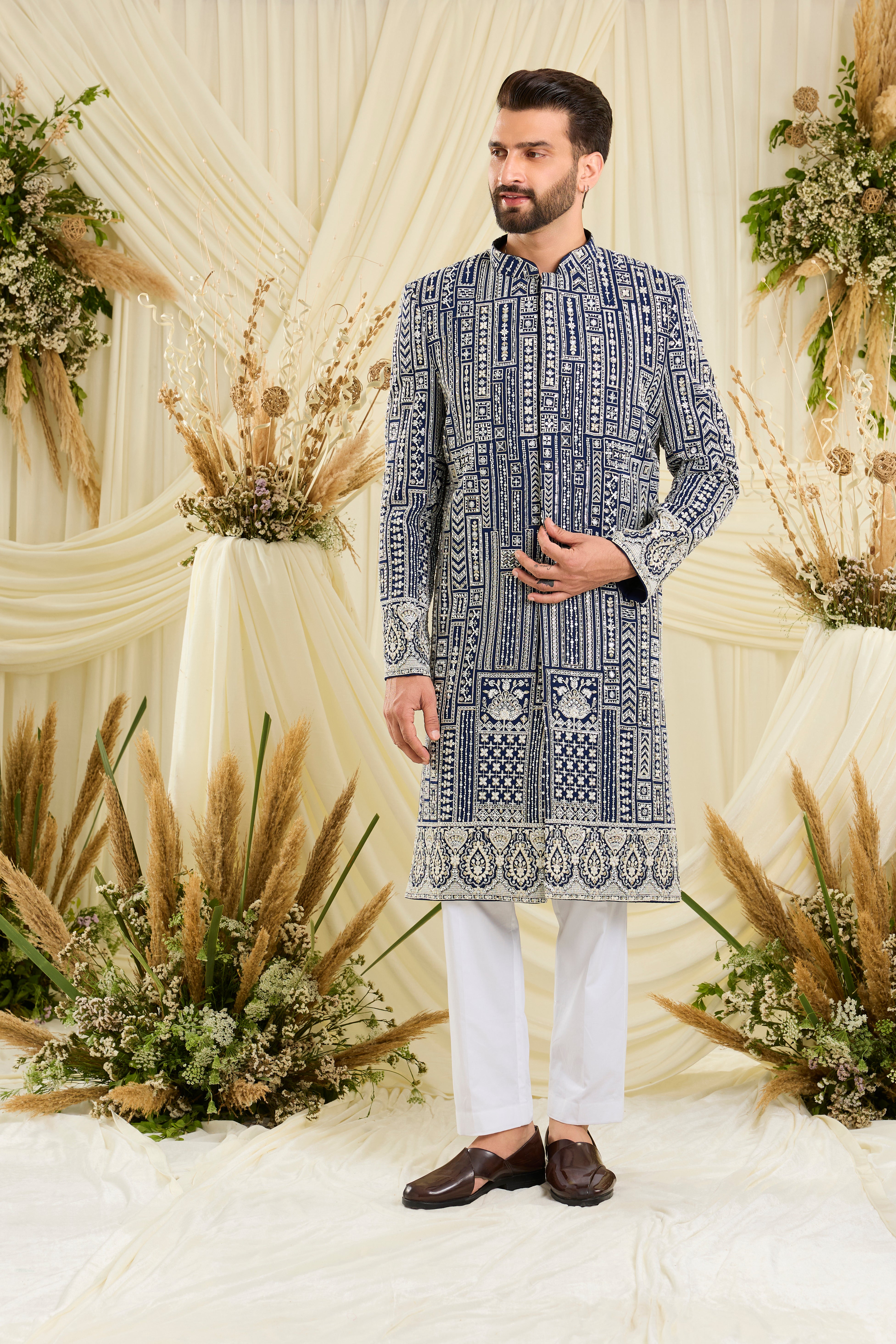 Royal blue sherwani with intricate white cut dana work and delicate sequins, crafted for a bold, ultra-luxurious statement.