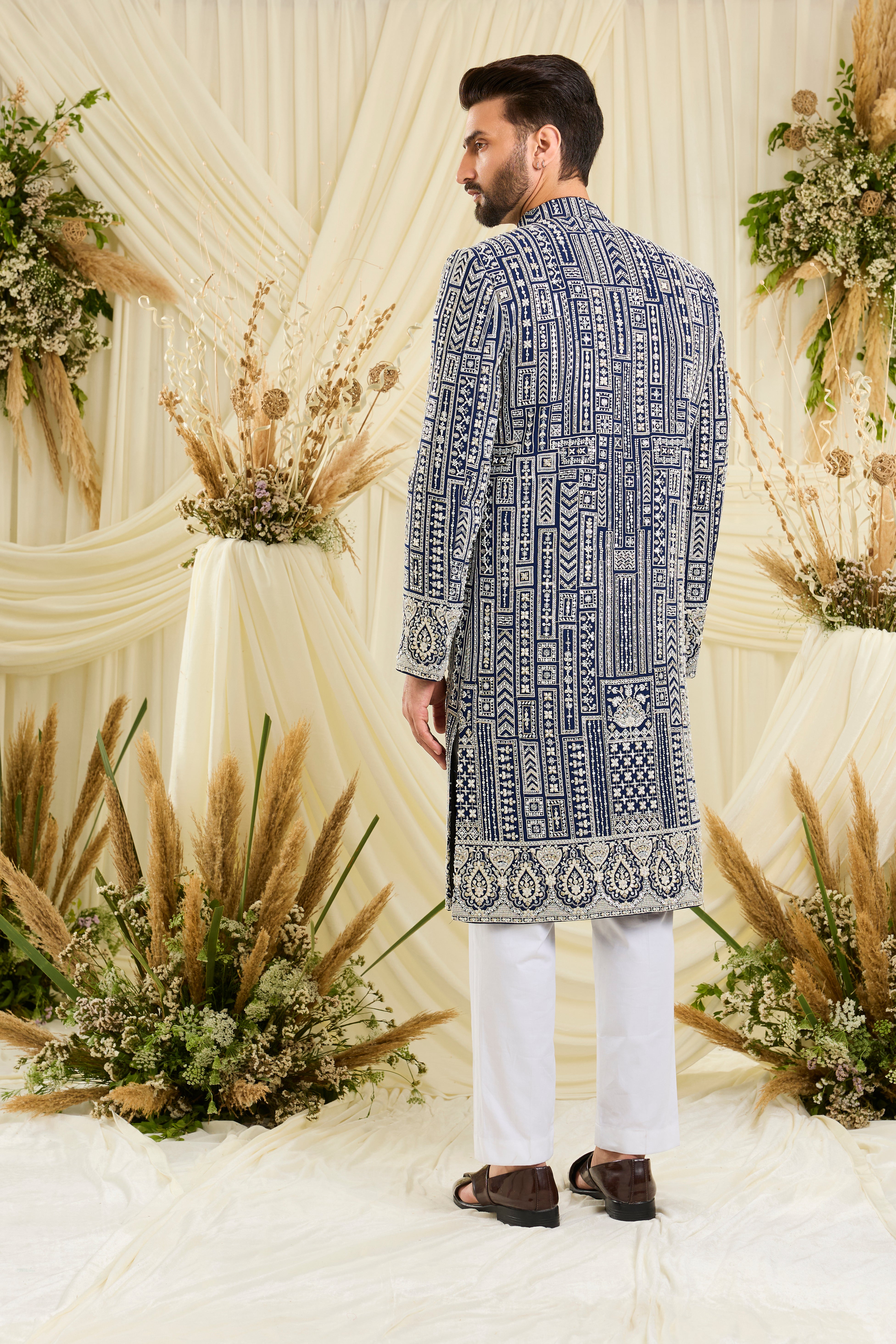 Royal blue sherwani with intricate white cut dana work and delicate sequins, crafted for a bold, ultra-luxurious statement.