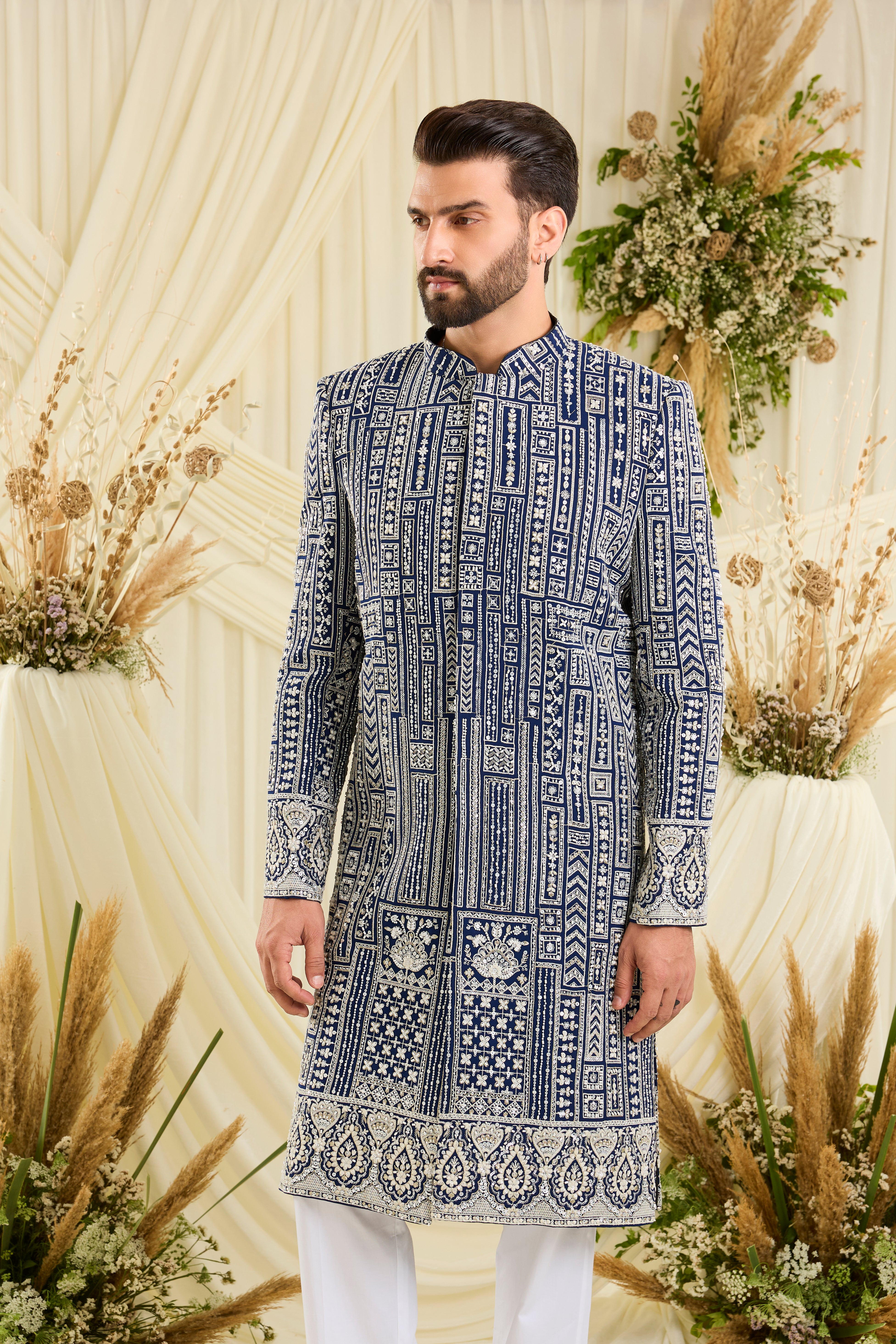 Royal blue sherwani with intricate white cut dana work and delicate sequins, crafted for a bold, ultra-luxurious statement.