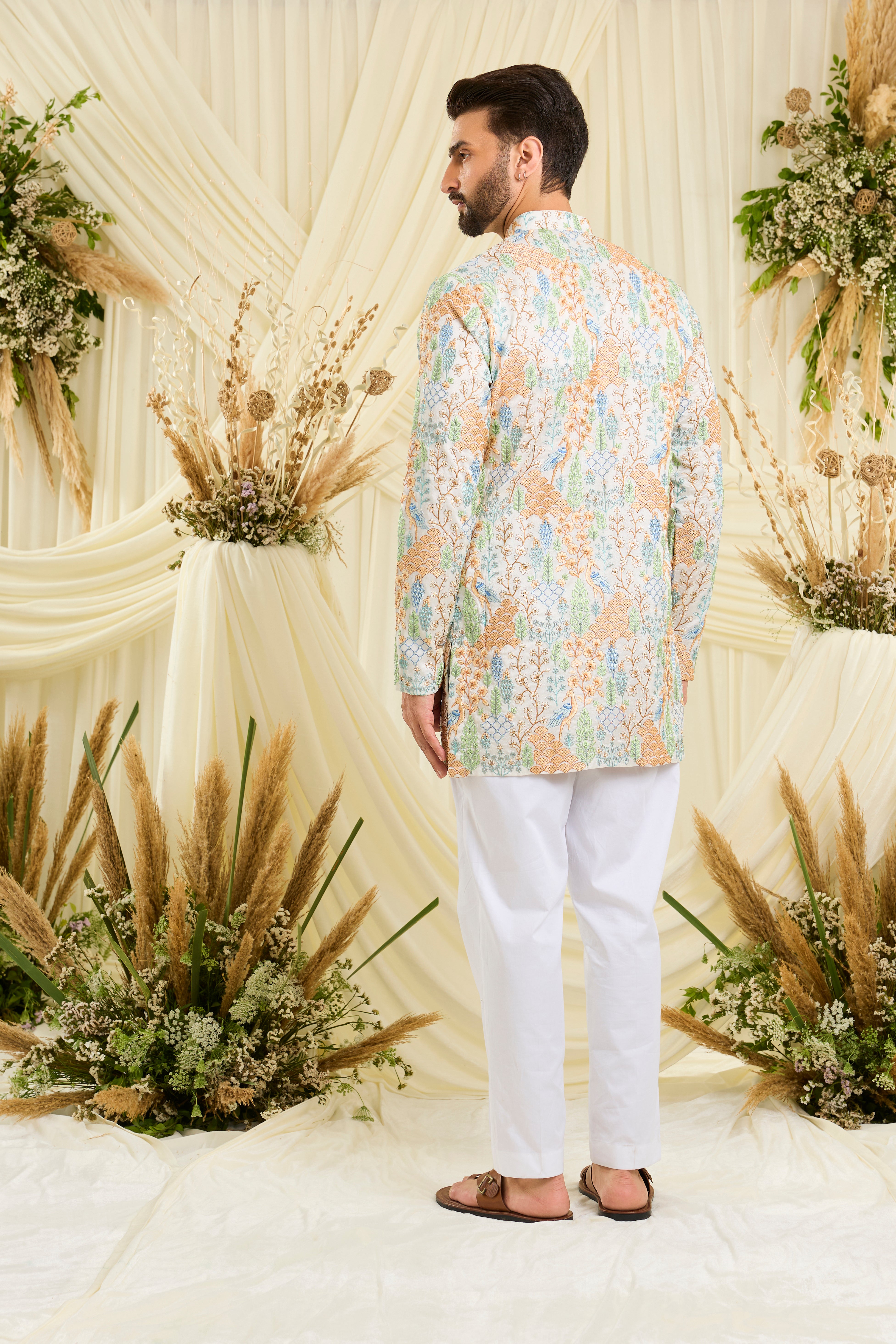 Ivory short kurta with heavy flora-fauna embroidery, multicolour threadwork, and delicate sequins for a richly detailed, luxe statement.