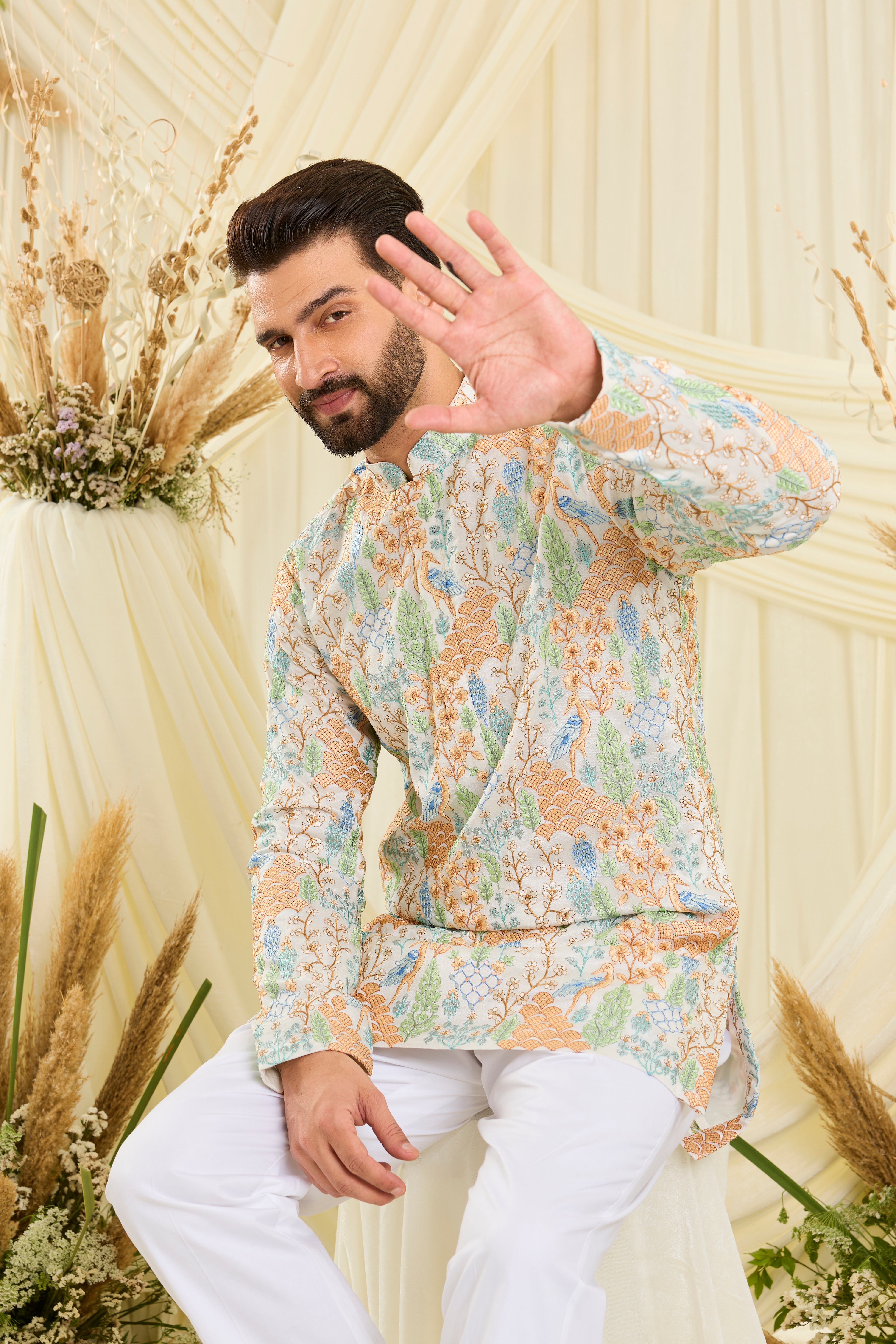 Ivory short kurta with heavy flora-fauna embroidery, multicolour threadwork, and delicate sequins for a richly detailed, luxe statement.