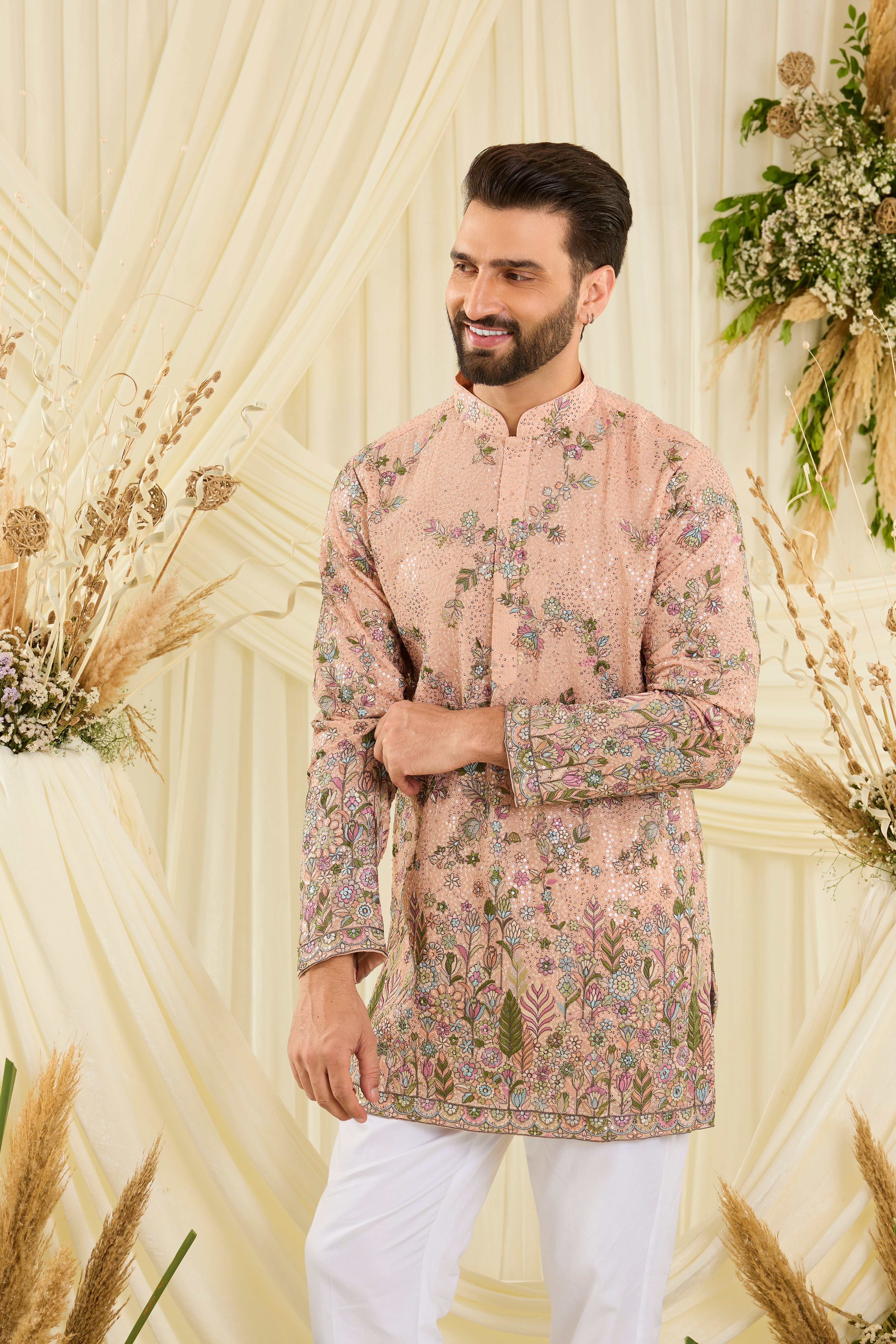Peach sequined short  kurta with intricate floral embroidery, multicolour threadwork, and delicate sequins for a fresh, elevated festive look.