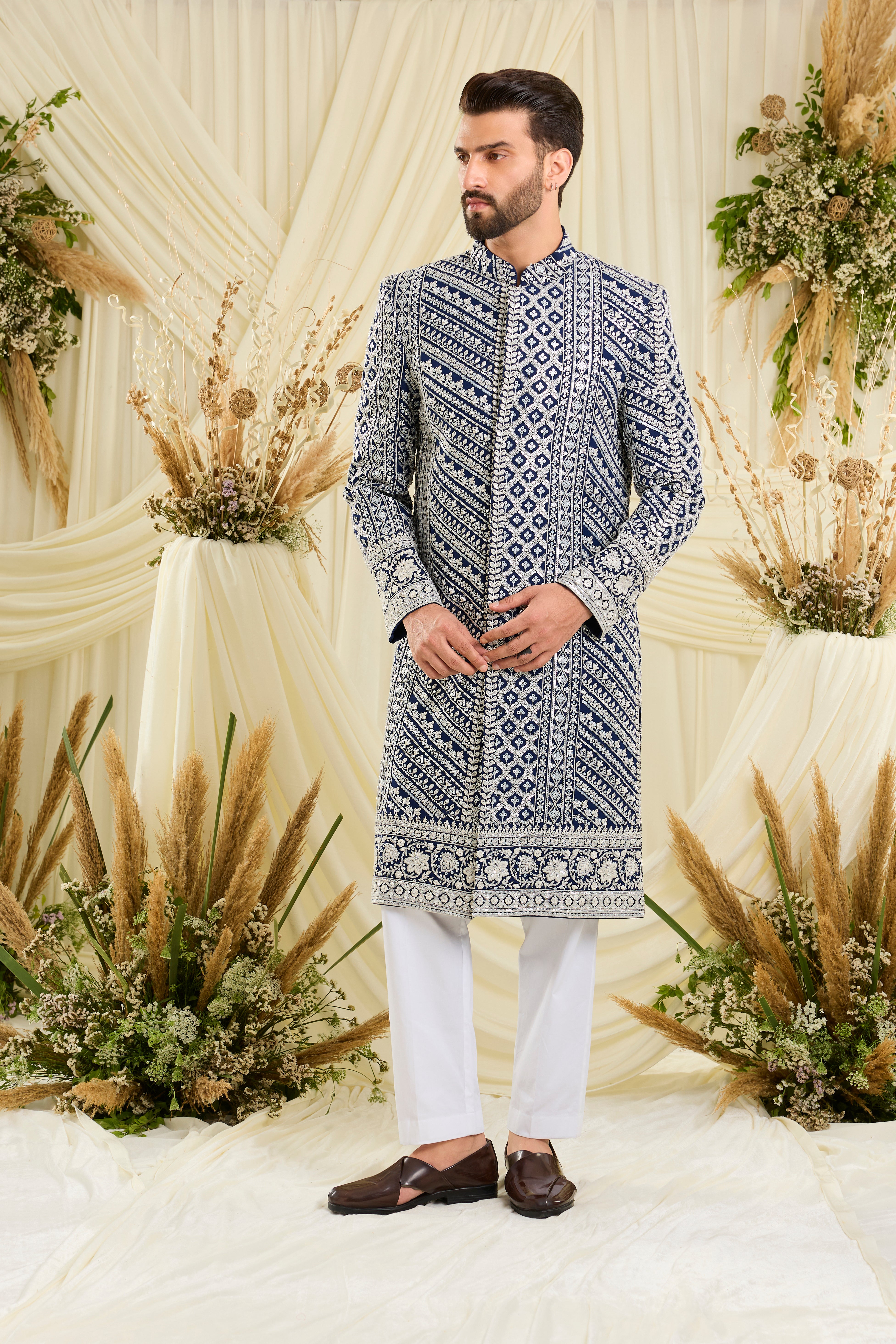 Royal blue sherwani with intricate white cut dana work and delicate sequins, crafted for a bold, ultra-luxurious statement.
