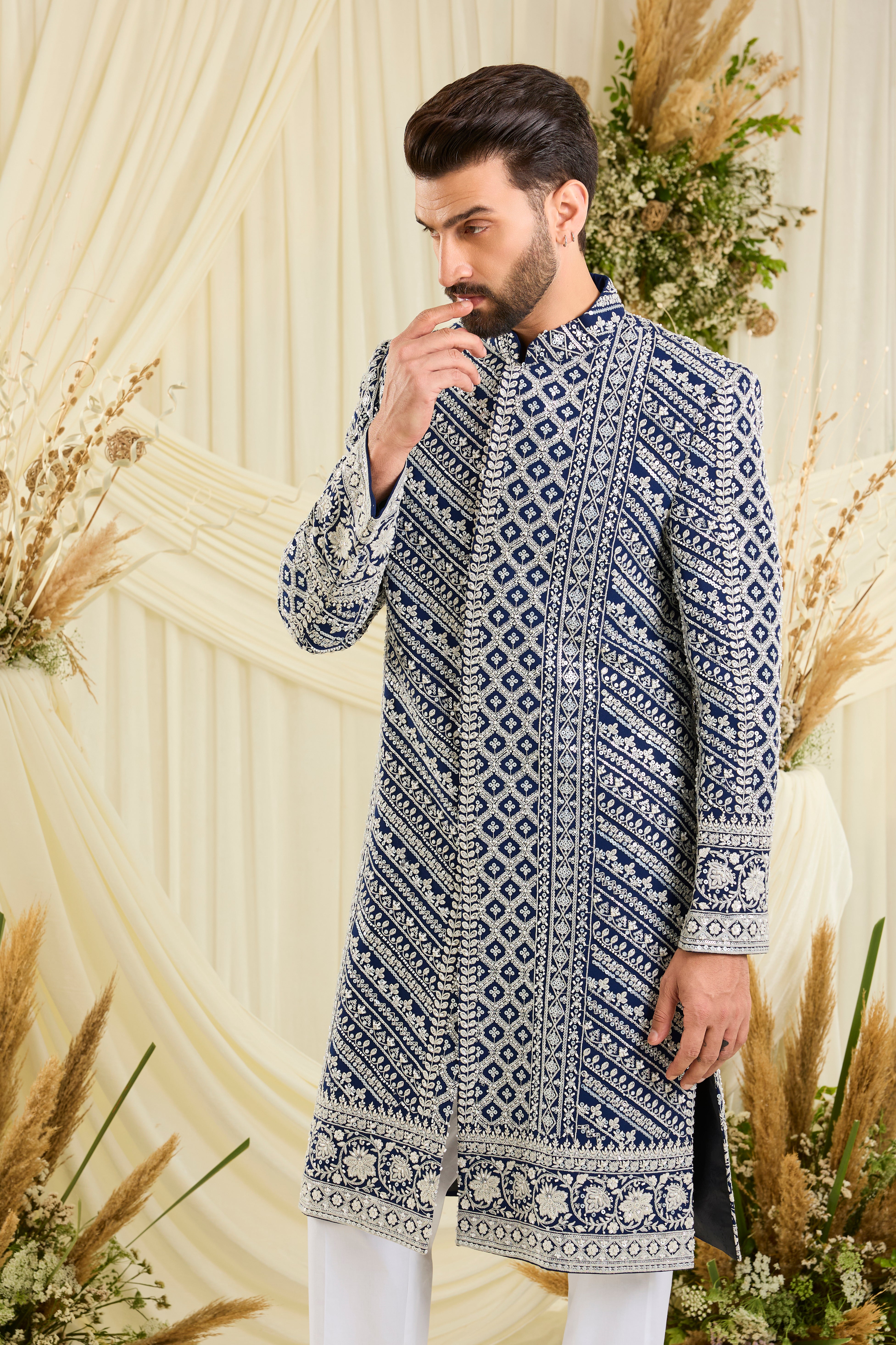 Royal blue sherwani with intricate white cut dana work and delicate sequins, crafted for a bold, ultra-luxurious statement.