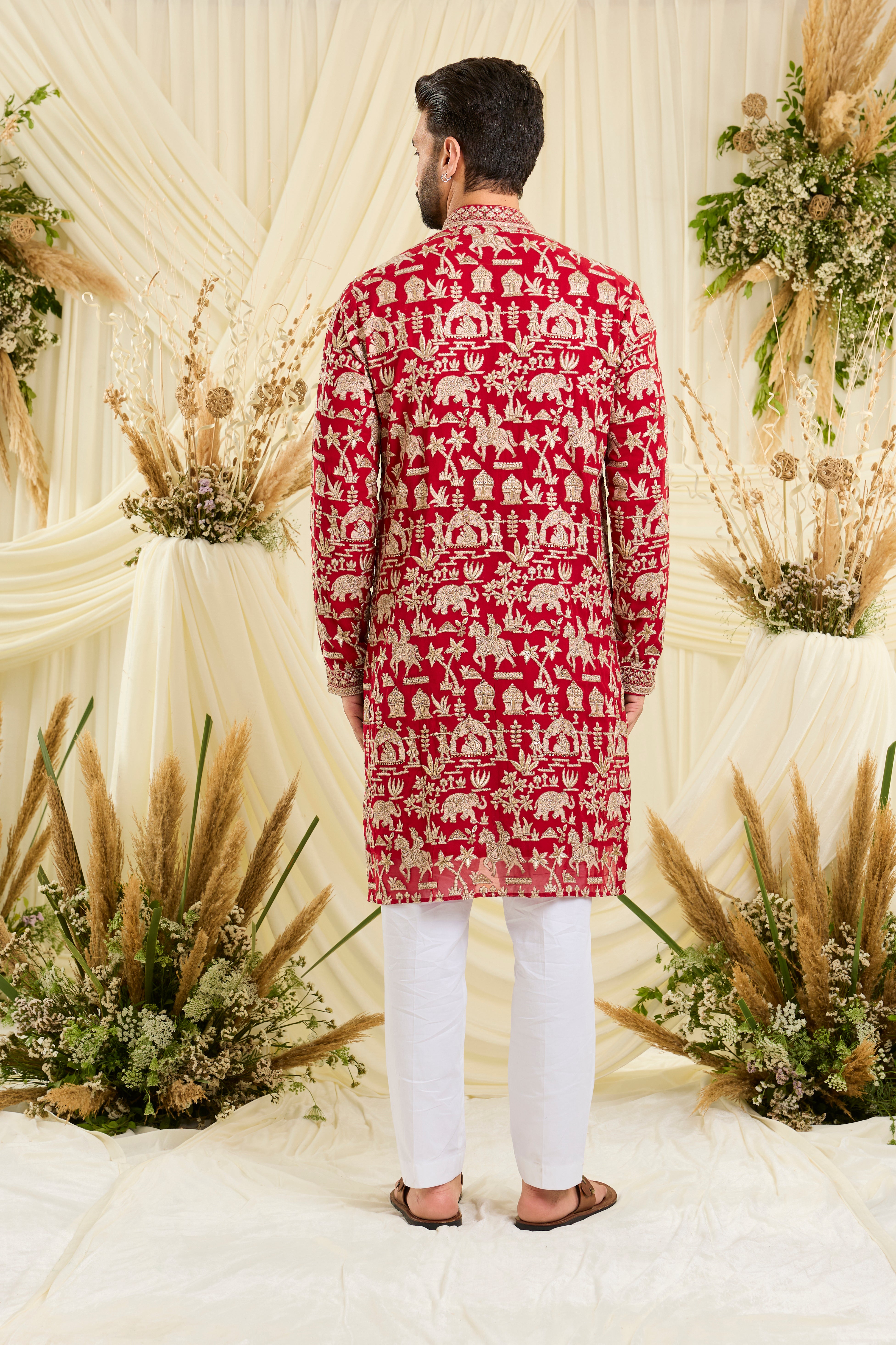 Red-pink Mughal era kurta with heavy zari work and a delicate neckline — regal, opulent, and timelessly refined