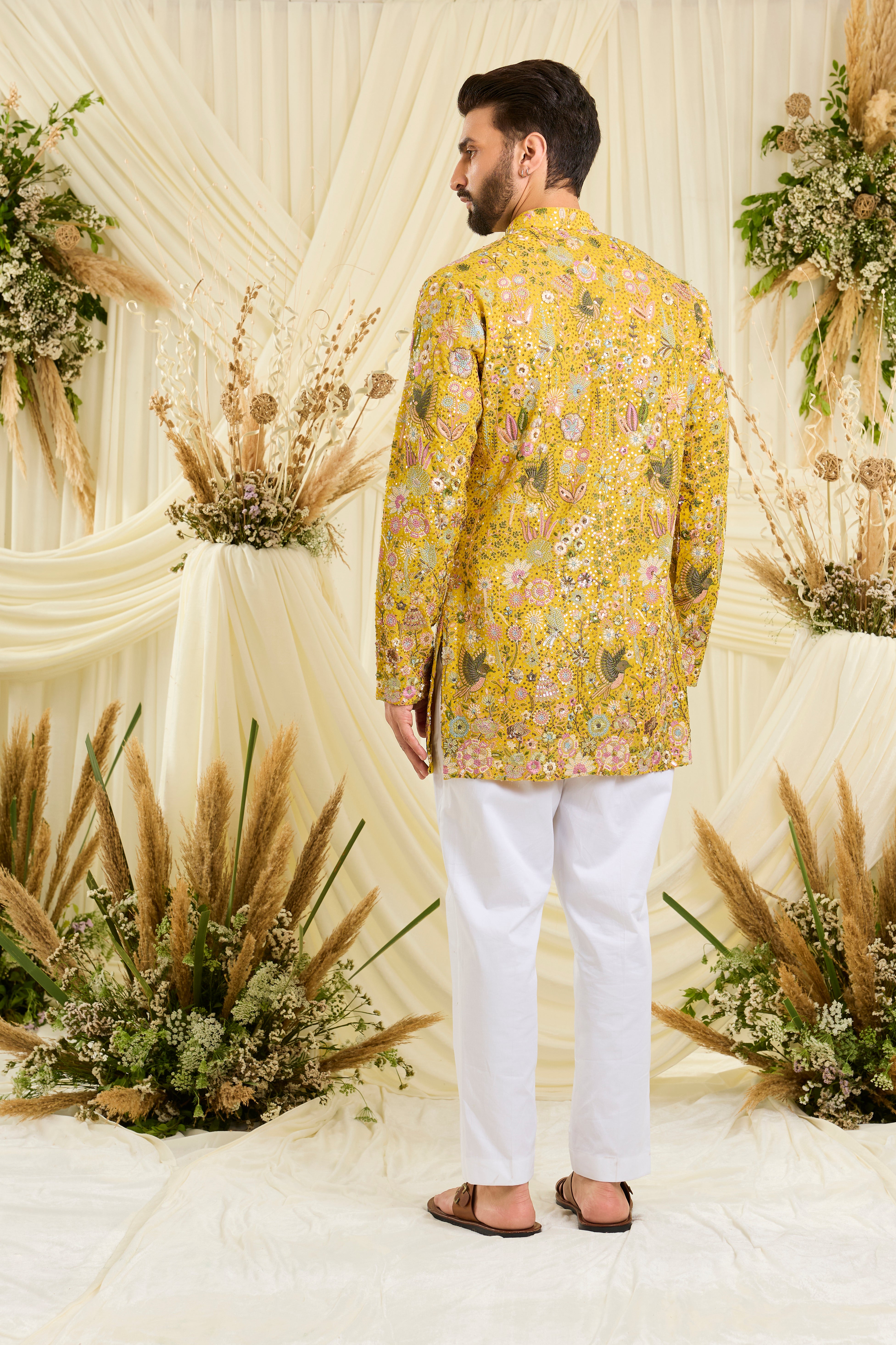 Yellow sequined  short kurta with intricate flora-fauna embroidery, multicolour threadwork, and detailed sequins for a fresh, elevated festive look.