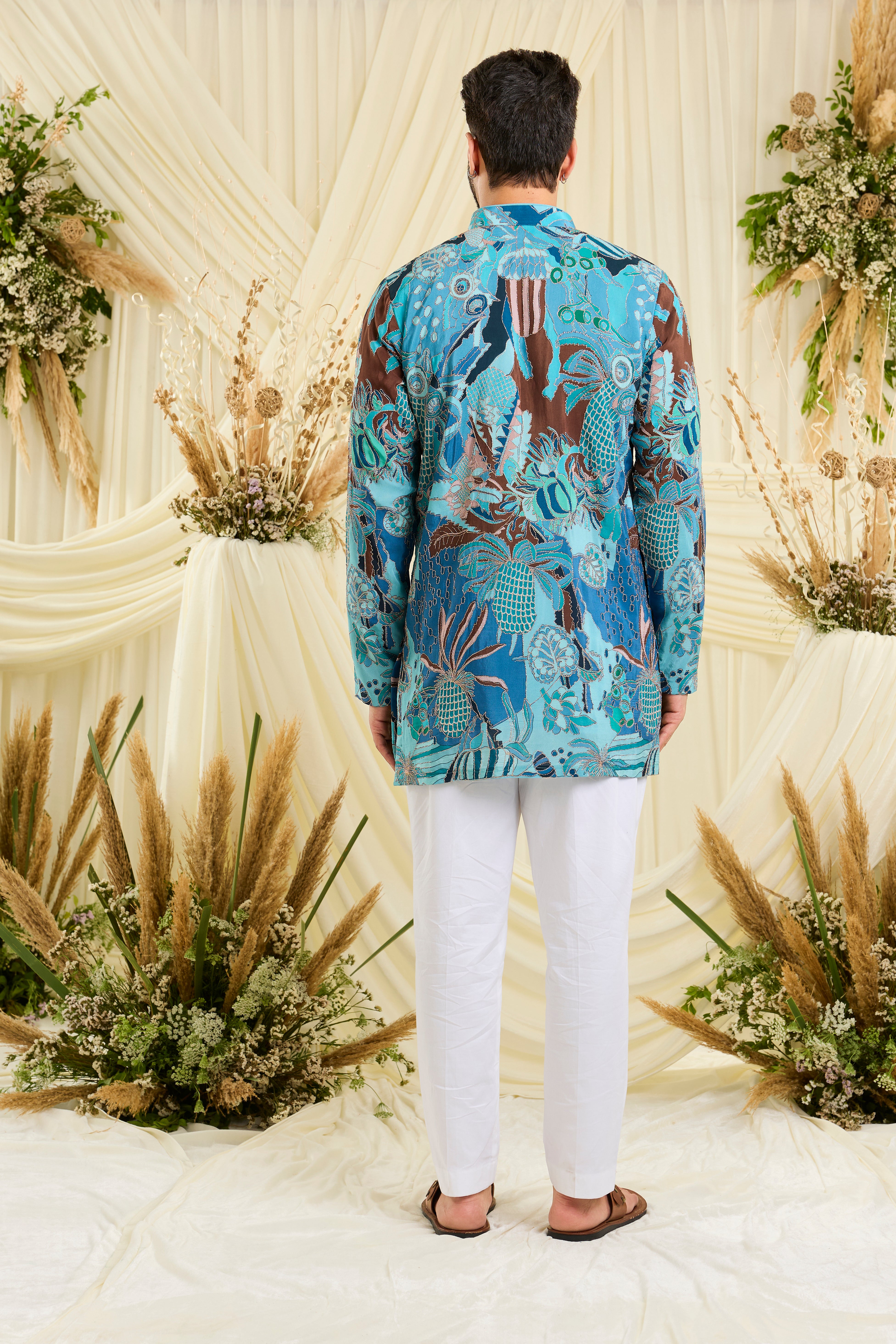 Blue abstract short kurta with multicolour prints and zari detailing — artistic, vibrant, and effortlessly luxurious.