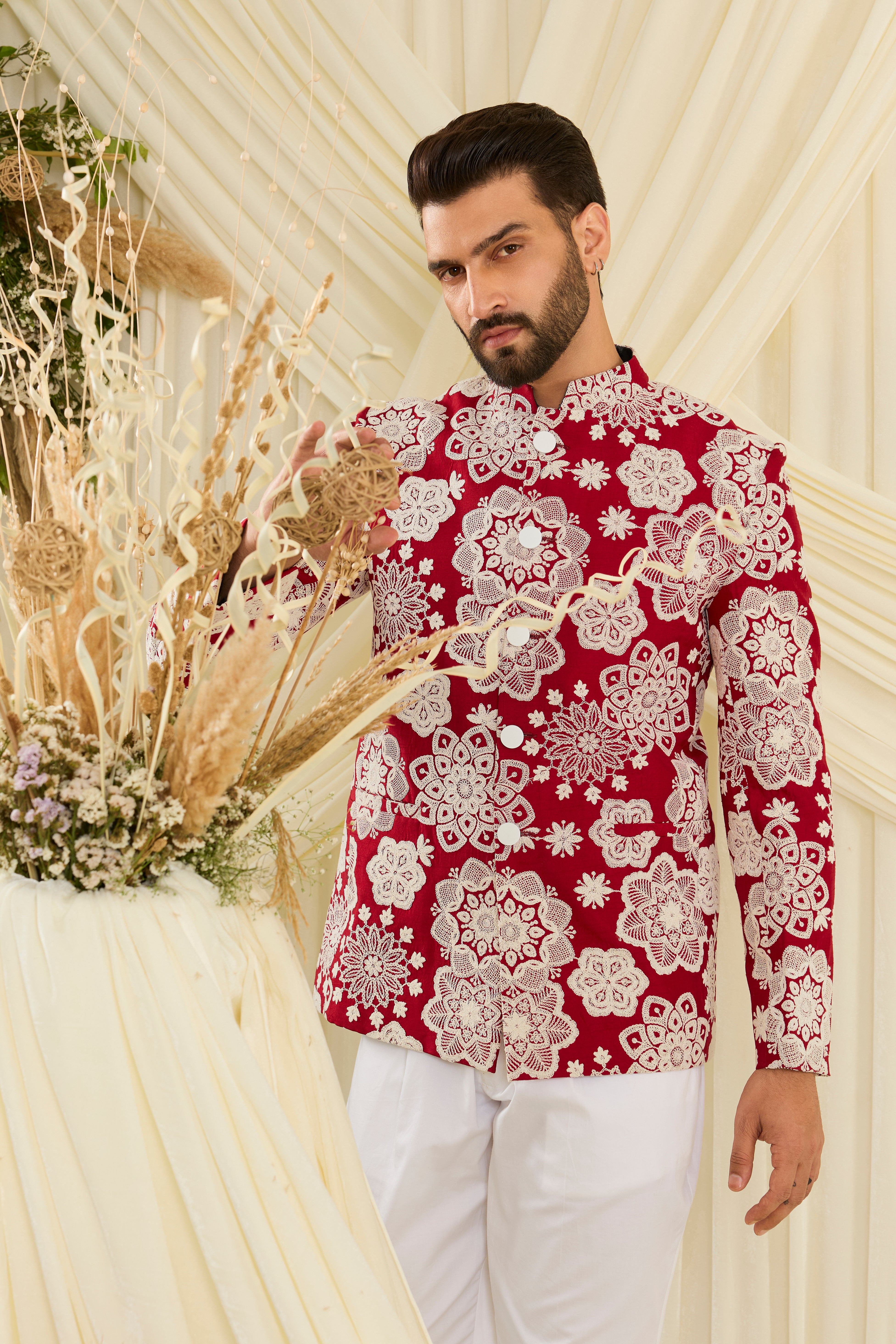 Red bandgala with intricate floral embroidery and heavy dori work, delivering a richly textured, bold festive statement.