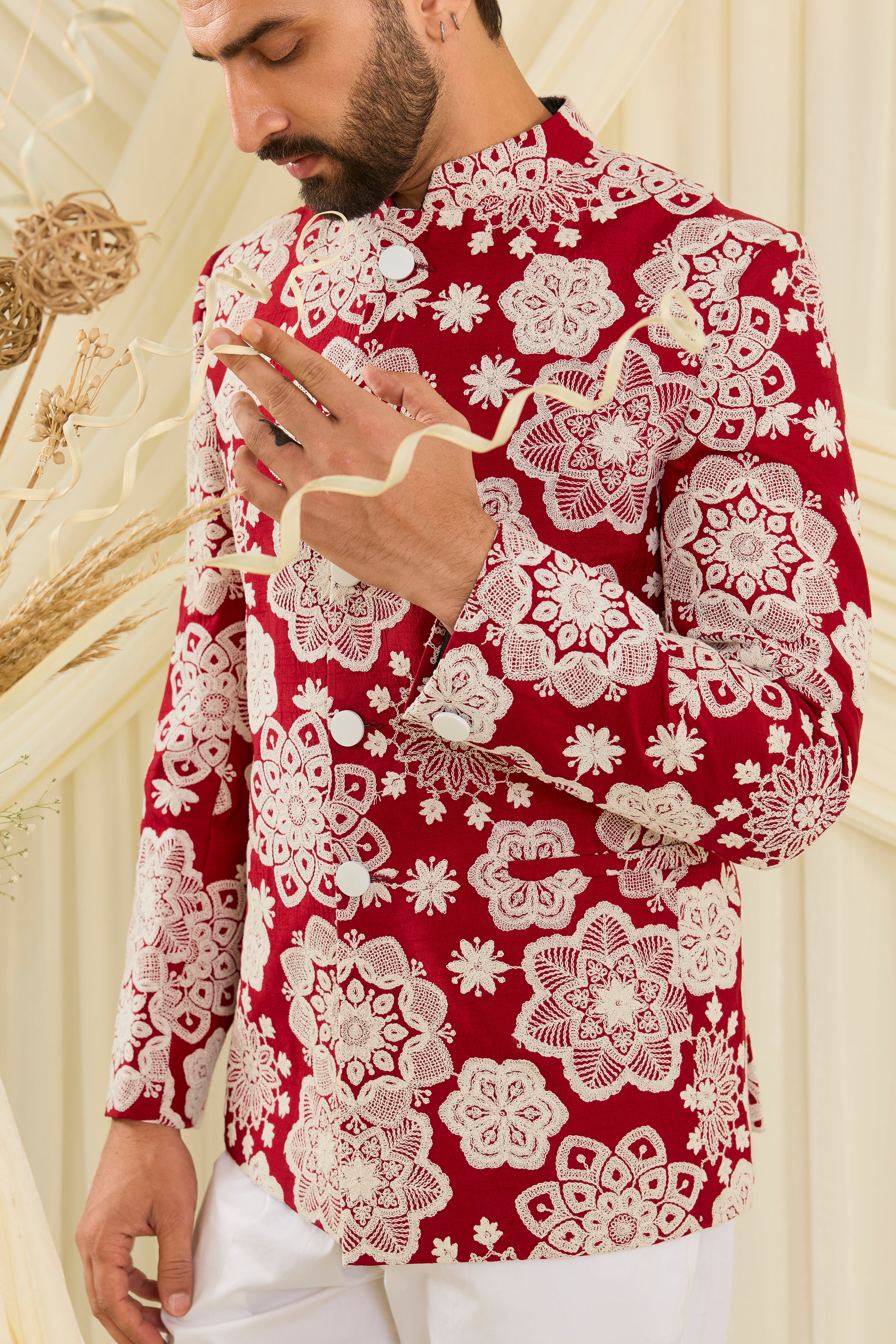Red bandgala with intricate floral embroidery and heavy dori work, delivering a richly textured, bold festive statement.