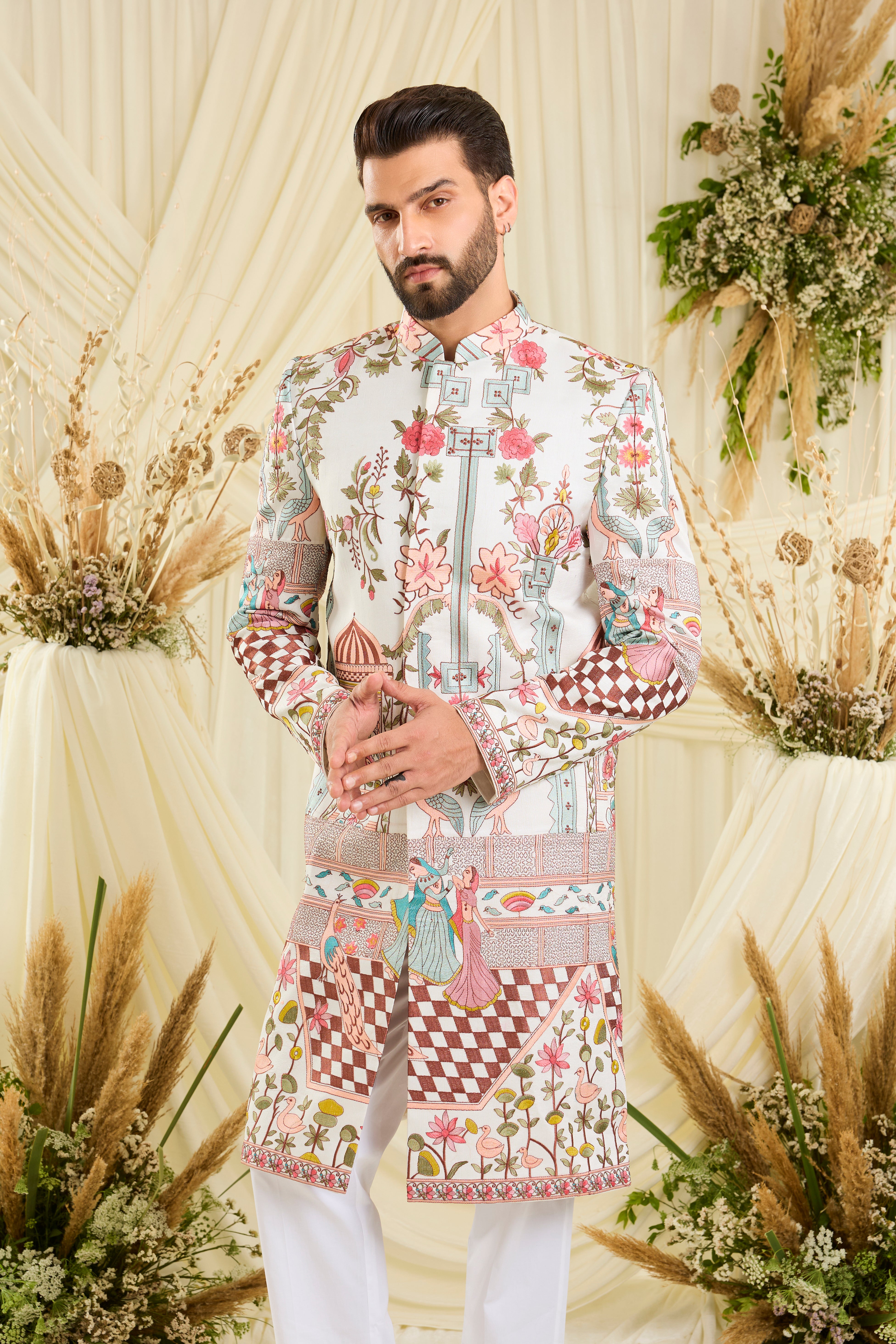 Opulent silk sherwani with Mughal darbars, peacocks, florals, and dancing royals — a masterpiece of imperial artistry.
