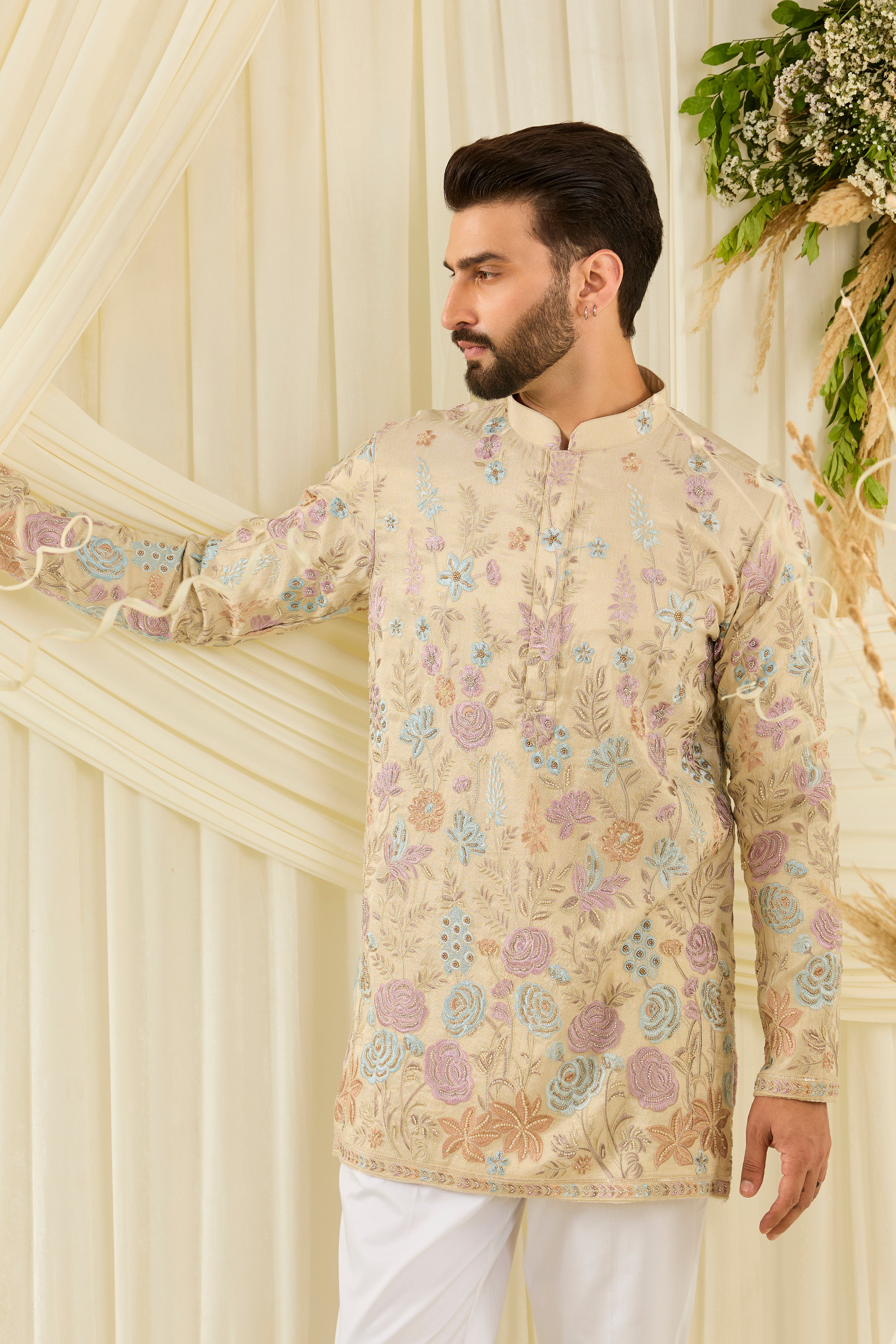 Cream-gold short kurta with floral embroidery, multicolour threadwork, and cut dana detailing — regal, luminous, and effortlessly sophisticated.