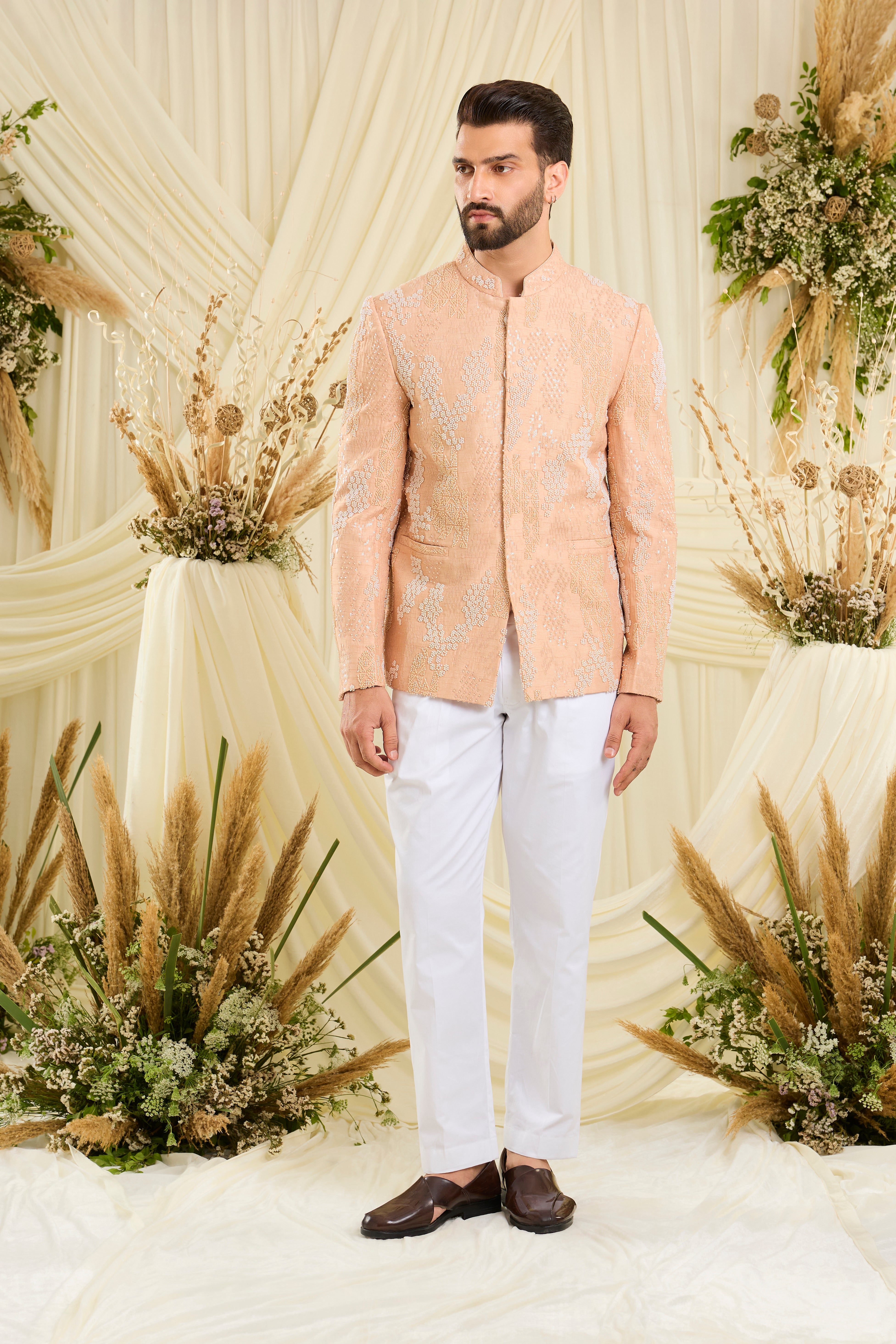 Peach bandhgala with hand embroidery, tonal cut dana, and ivory beads — impeccably regal, refined, and royally luxurious.