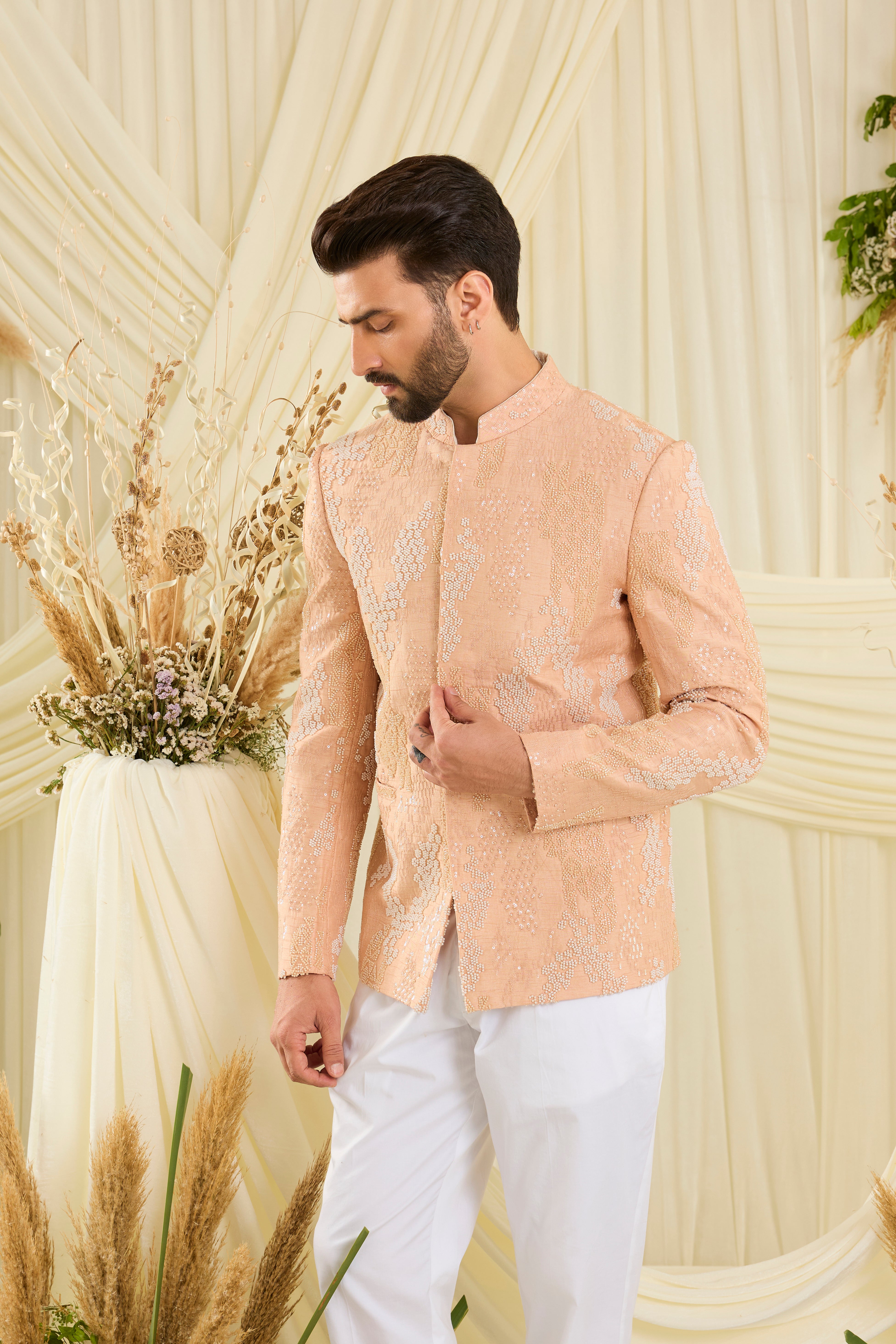 Peach bandhgala with hand embroidery, tonal cut dana, and ivory beads — impeccably regal, refined, and royally luxurious.