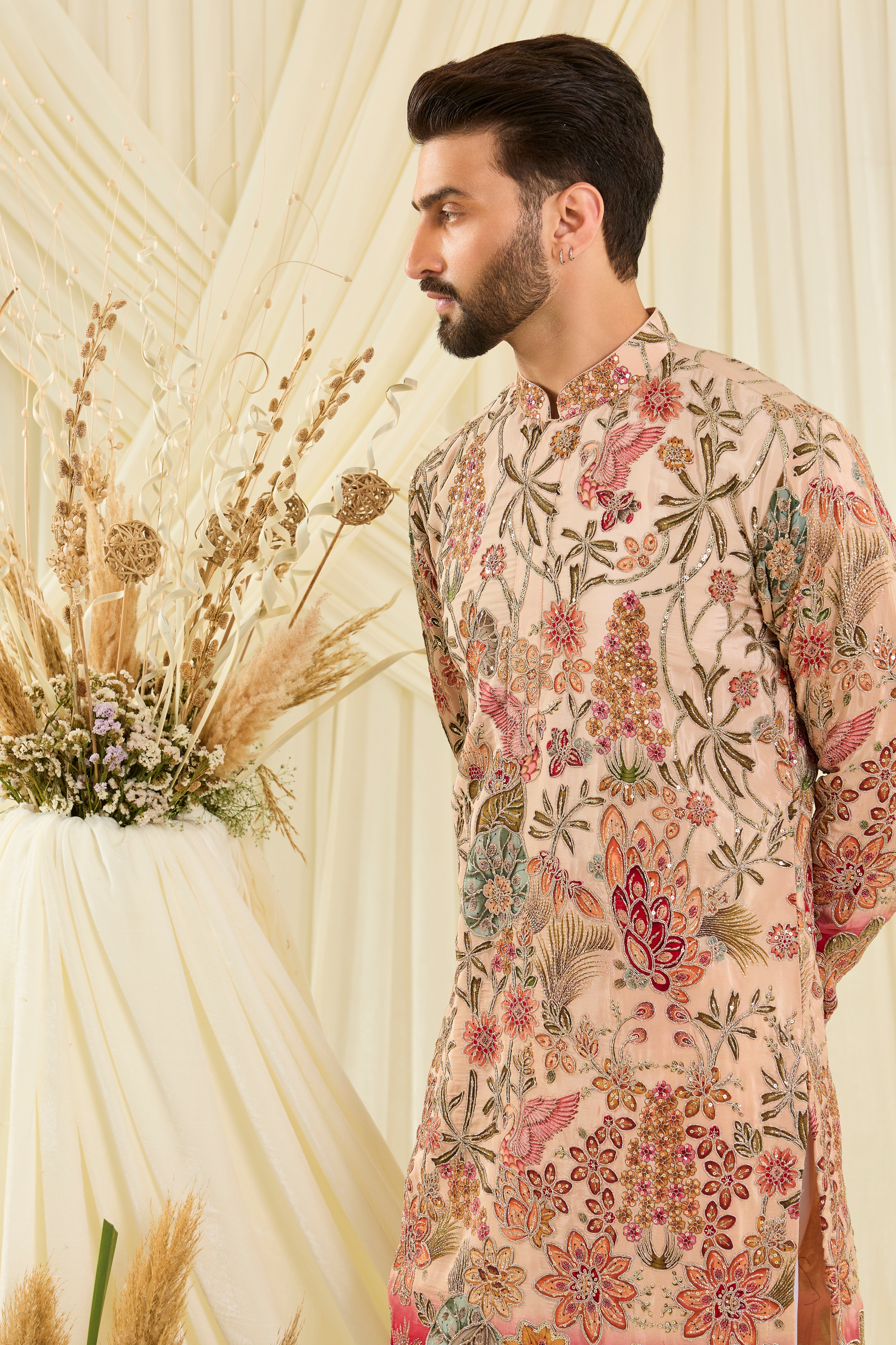 Pastel peach  kurta with intricate floral embroidery, rich zari detailing, and delicate sequins for a refined, luminous festive statement.