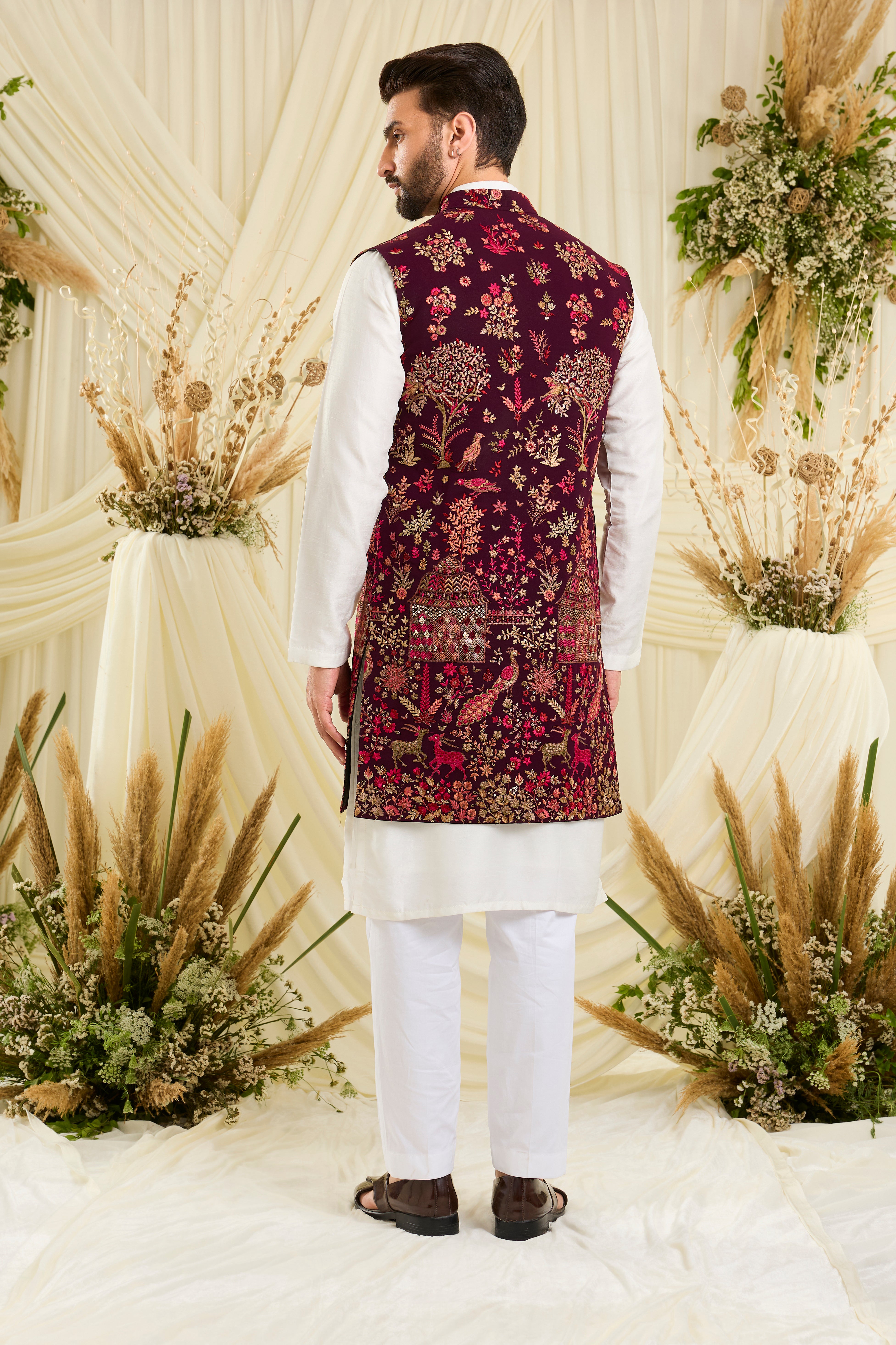 Wine / maroon long open jacket with intricate flora-fauna embroidery, multicolour threadwork, and delicate sequins for a fresh, elevated festive look.