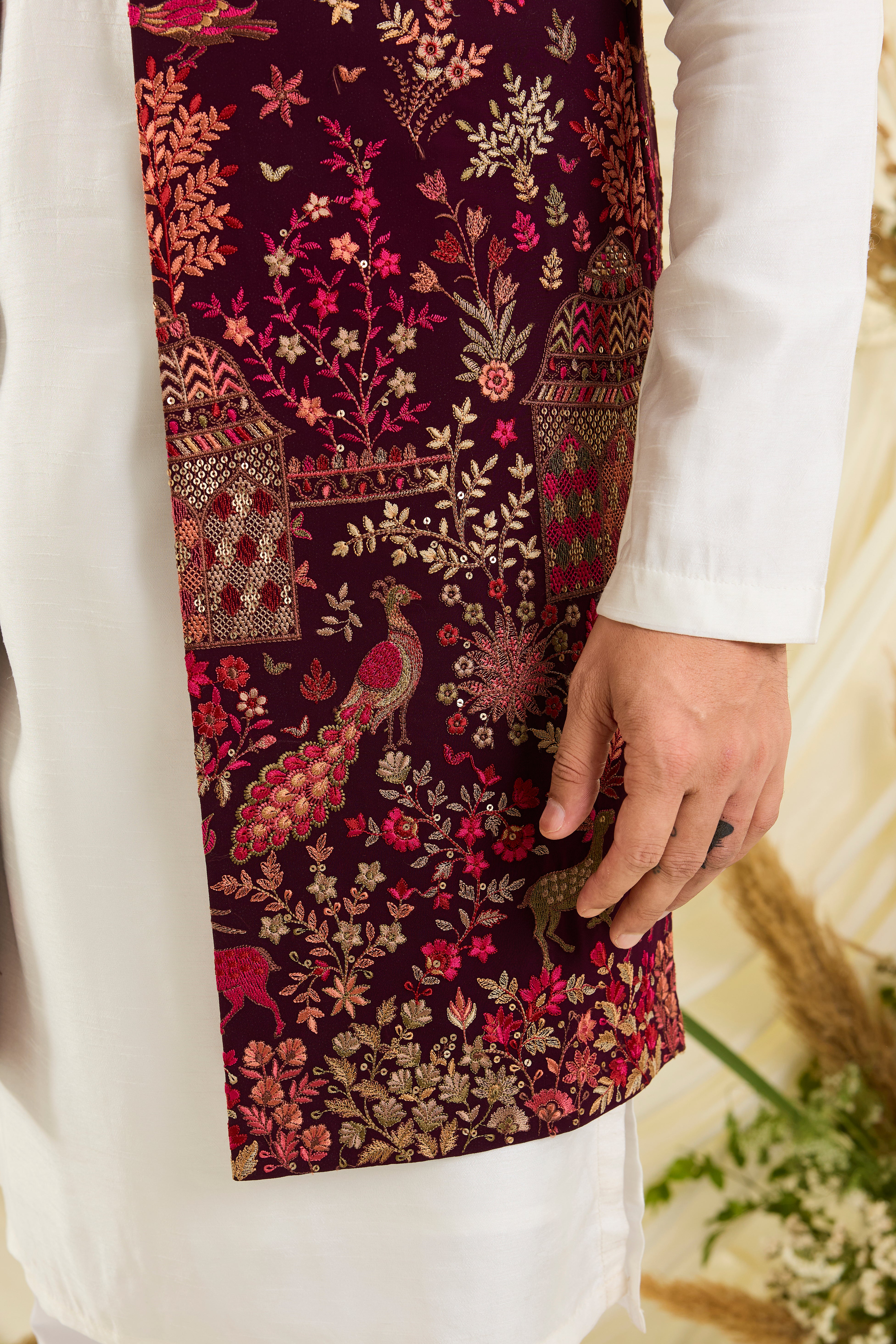 Wine / maroon long open jacket with intricate flora-fauna embroidery, multicolour threadwork, and delicate sequins for a fresh, elevated festive look.