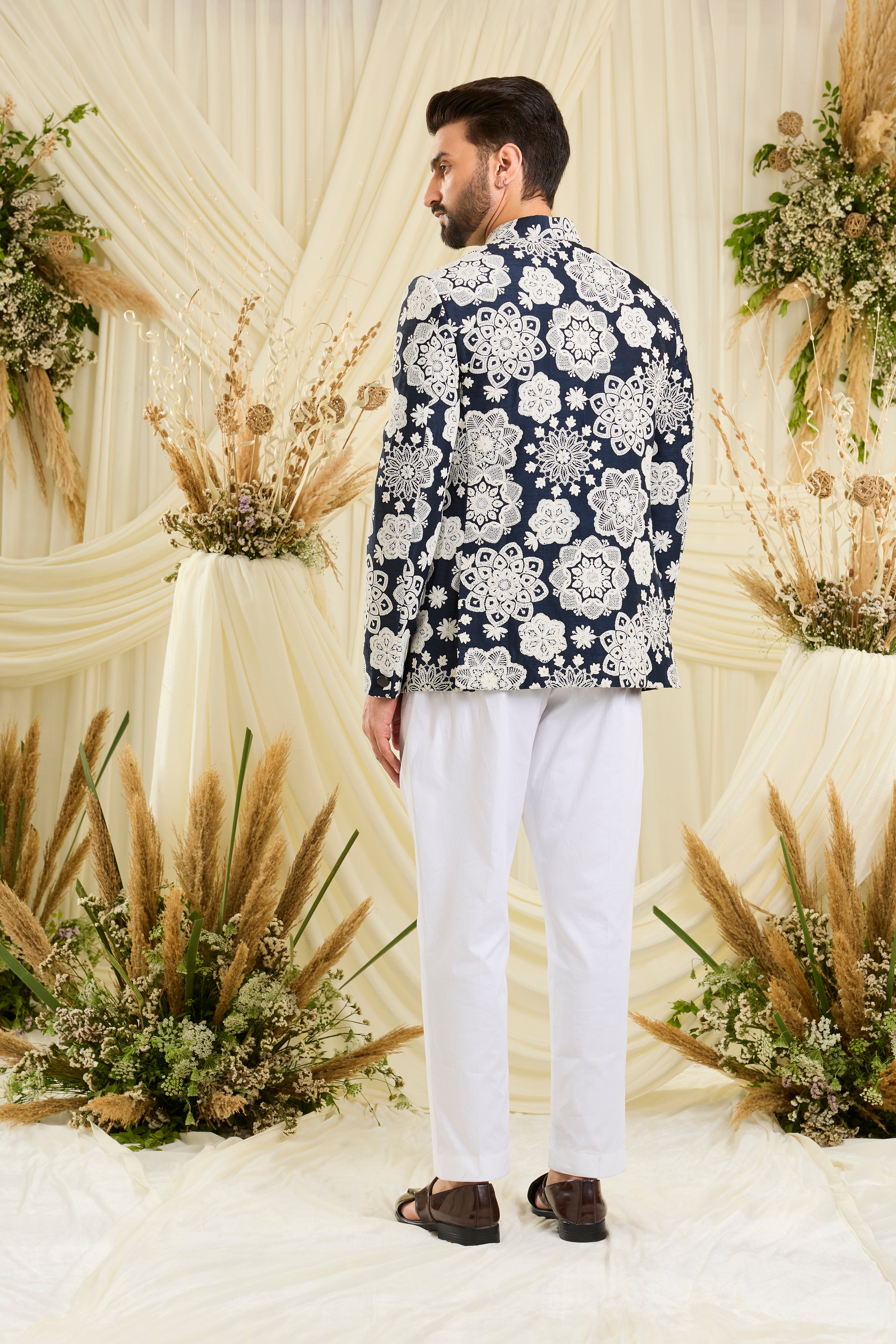 Red bandgala with intricate floral embroidery and heavy dori work, delivering a richly textured, bold festive statement.