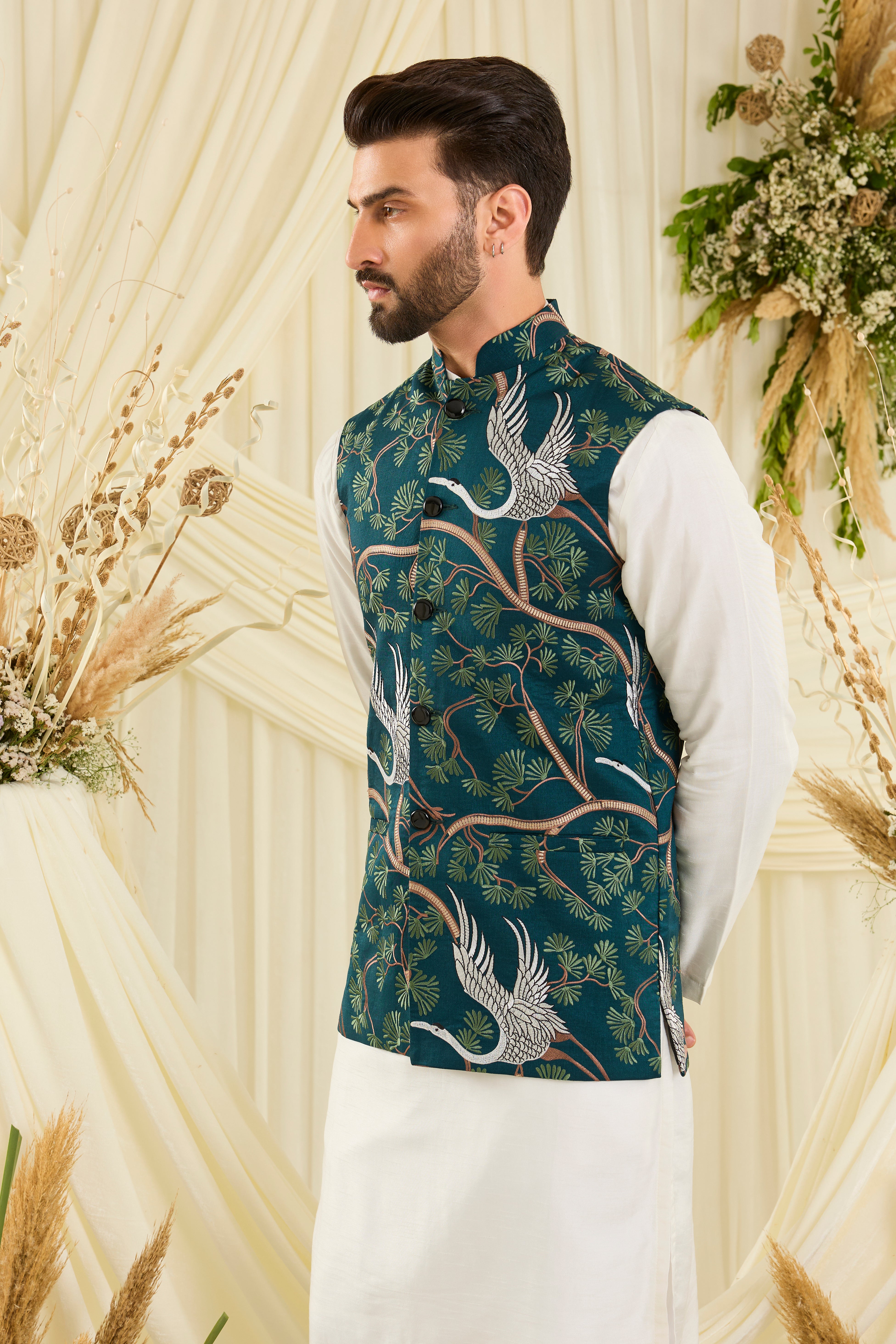 Teal Nehru jacket with intricate floral patterns and elegant white flamingo motifs, blending artistic charm with refined sophistication.