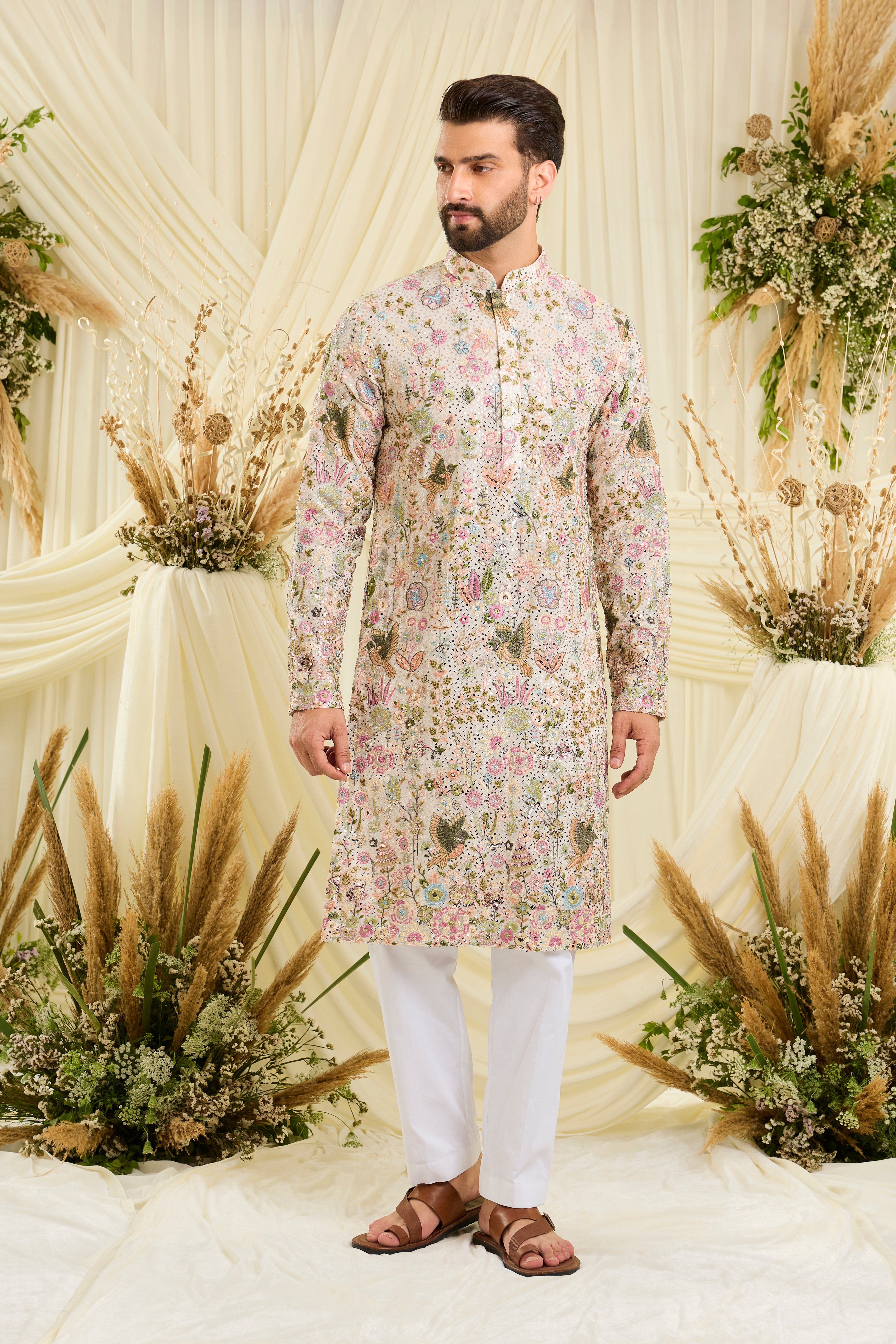 Ivory sequined kurta with intricate flora-fauna embroidery, multicolour threadwork, and detailed sequins for a fresh, elevated festive look.
