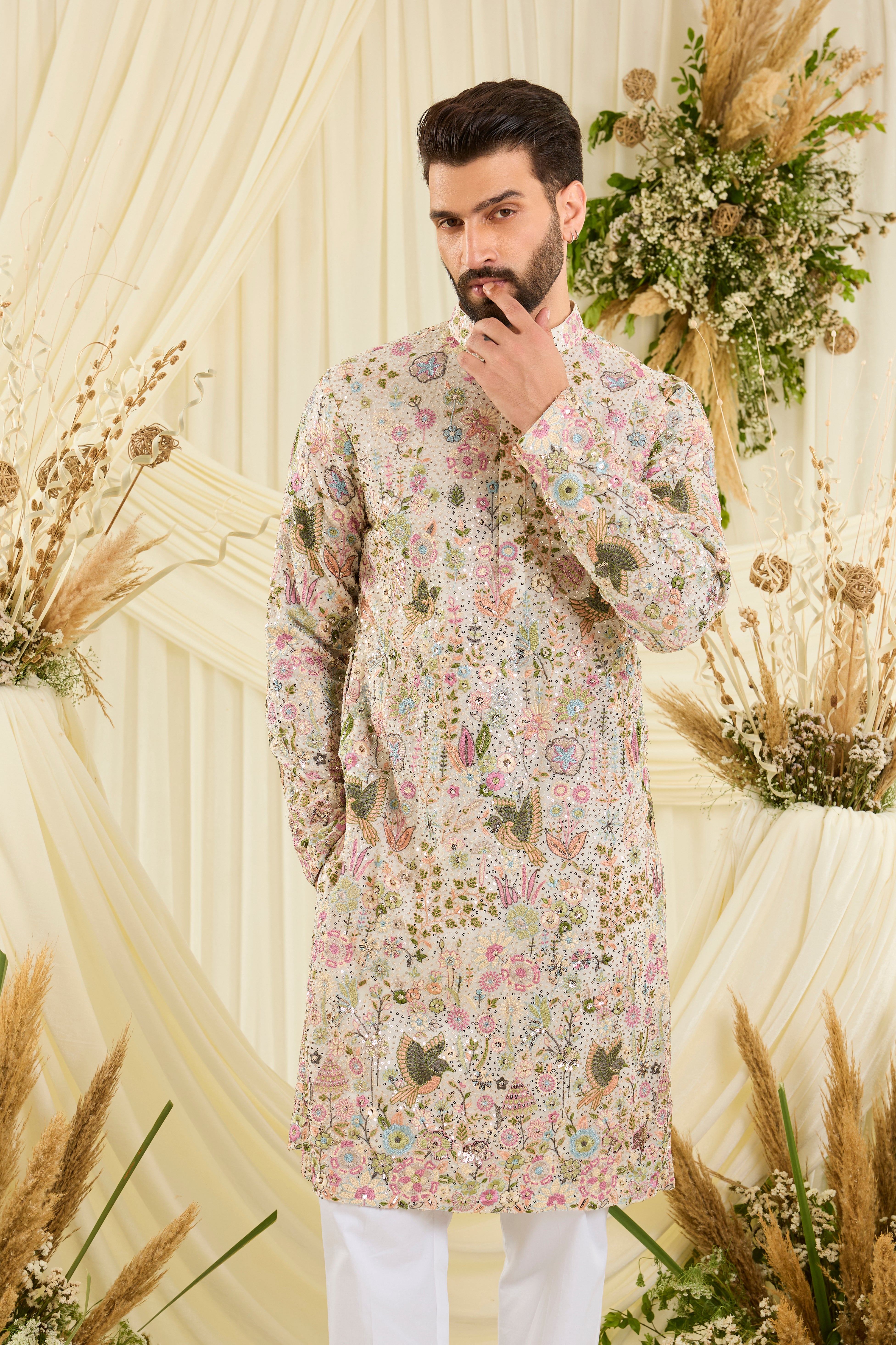 Ivory sequined kurta with intricate flora-fauna embroidery, multicolour threadwork, and detailed sequins for a fresh, elevated festive look.
