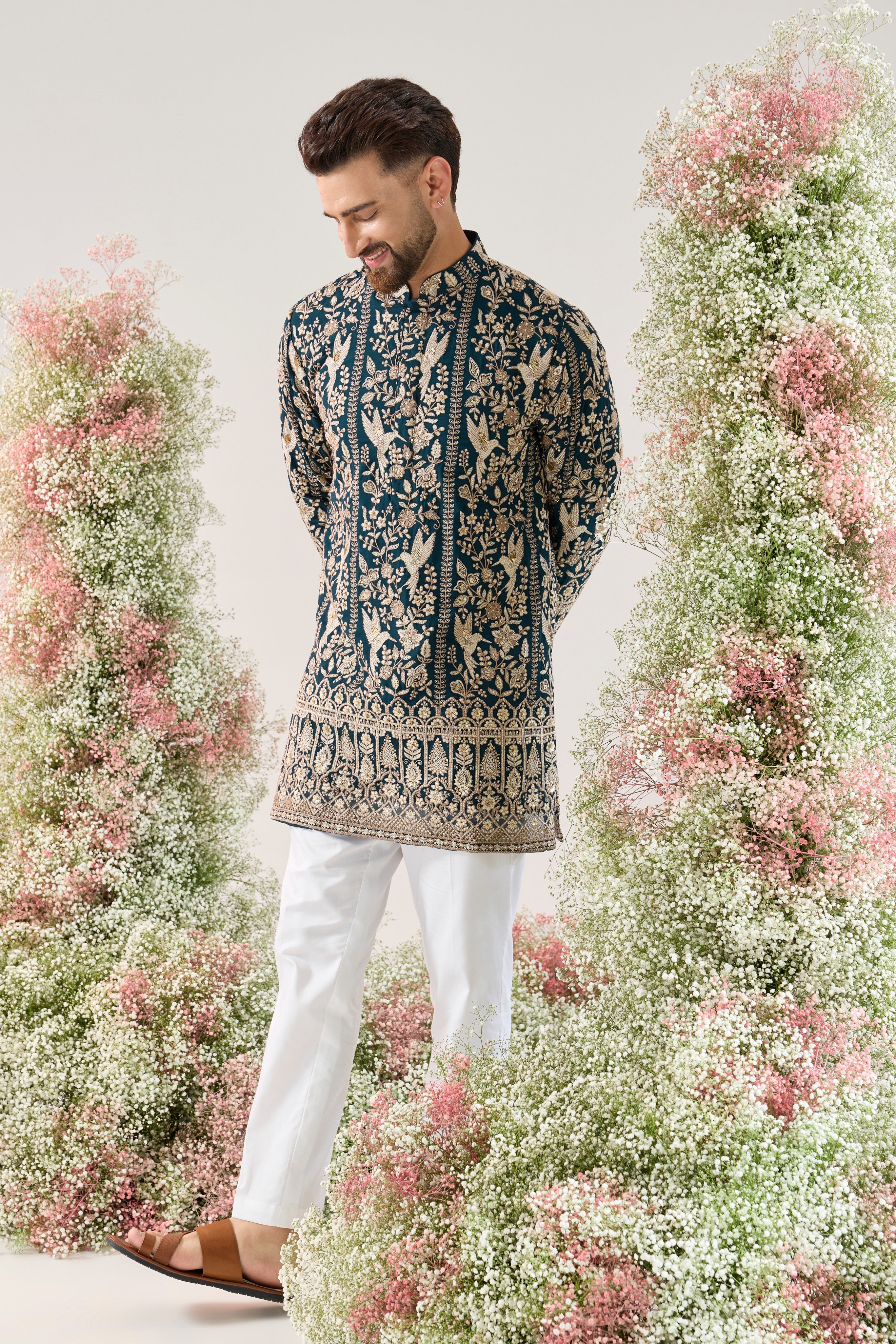 teal short chikankari kurta with intricate flora and fauna embroidery