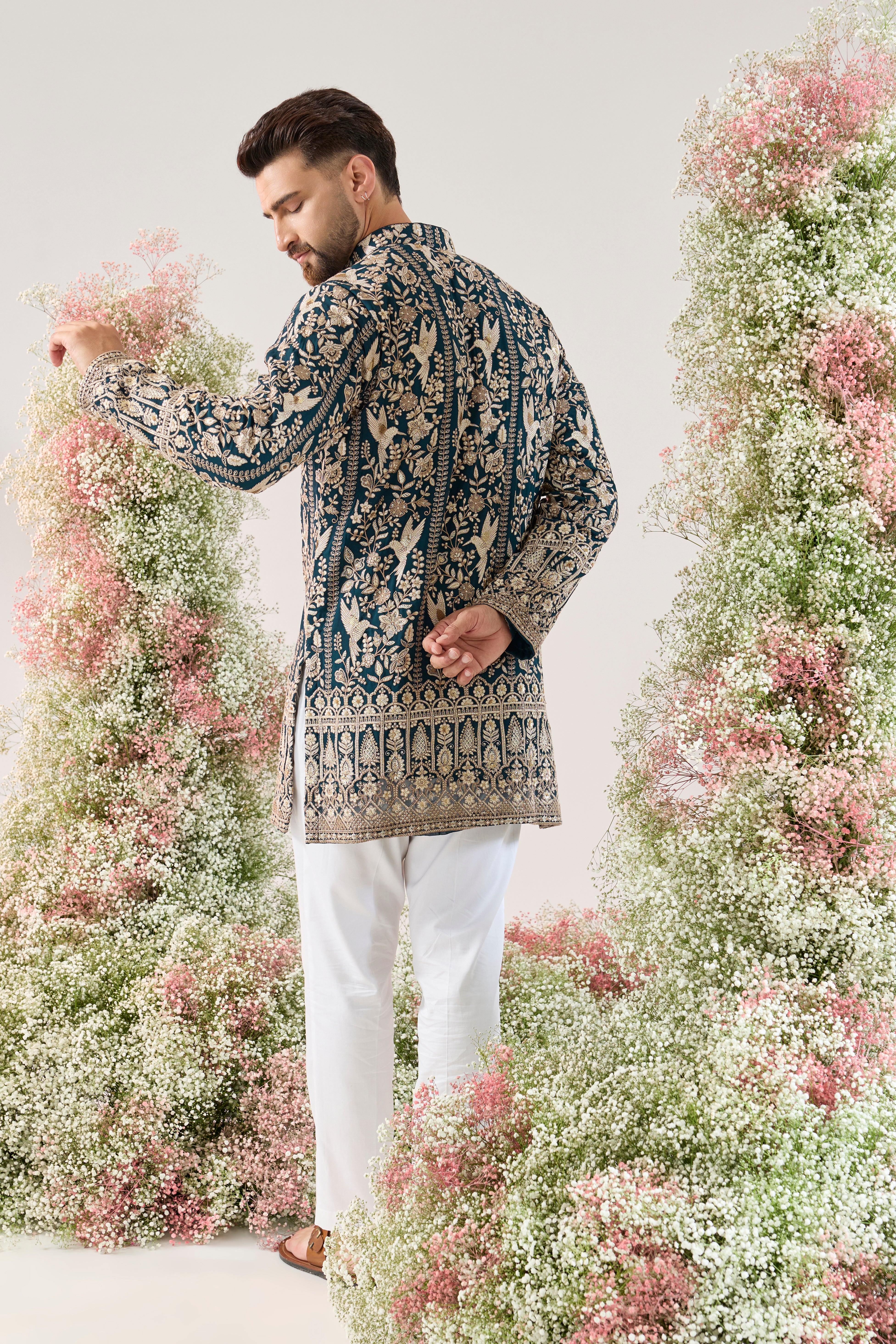 teal short chikankari kurta with intricate flora and fauna embroidery