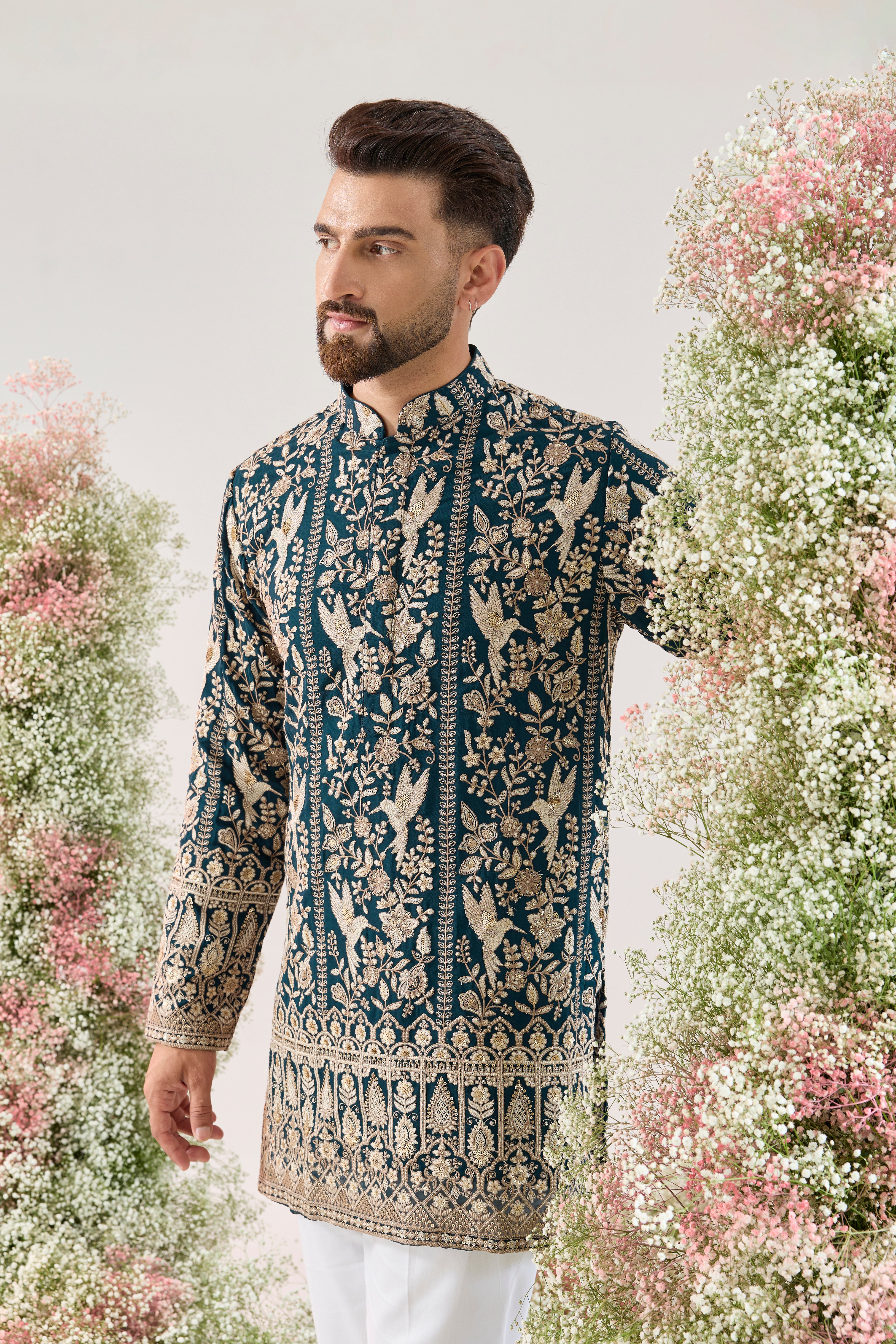 teal short chikankari kurta with intricate flora and fauna embroidery