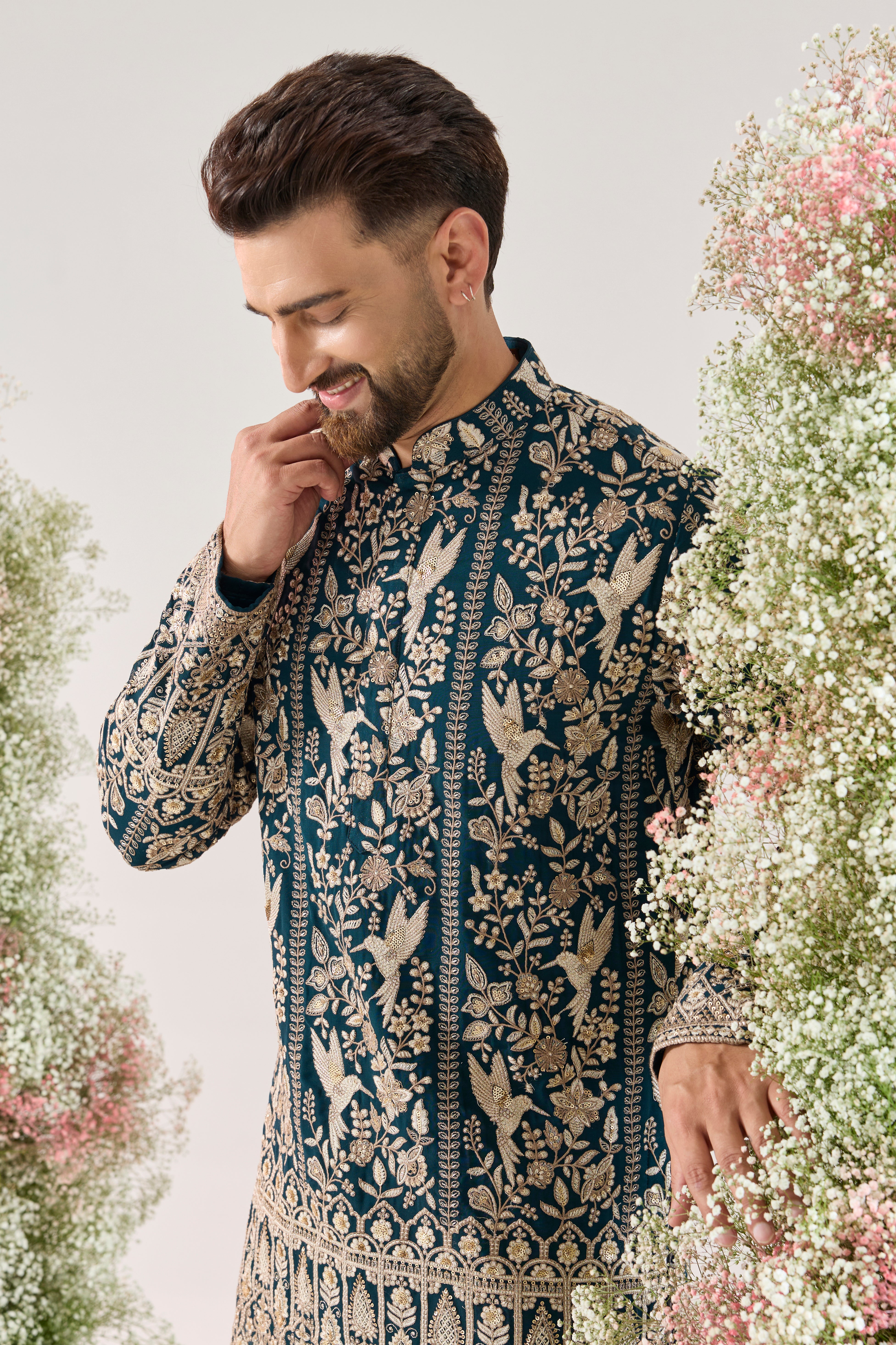teal short chikankari kurta with intricate flora and fauna embroidery
