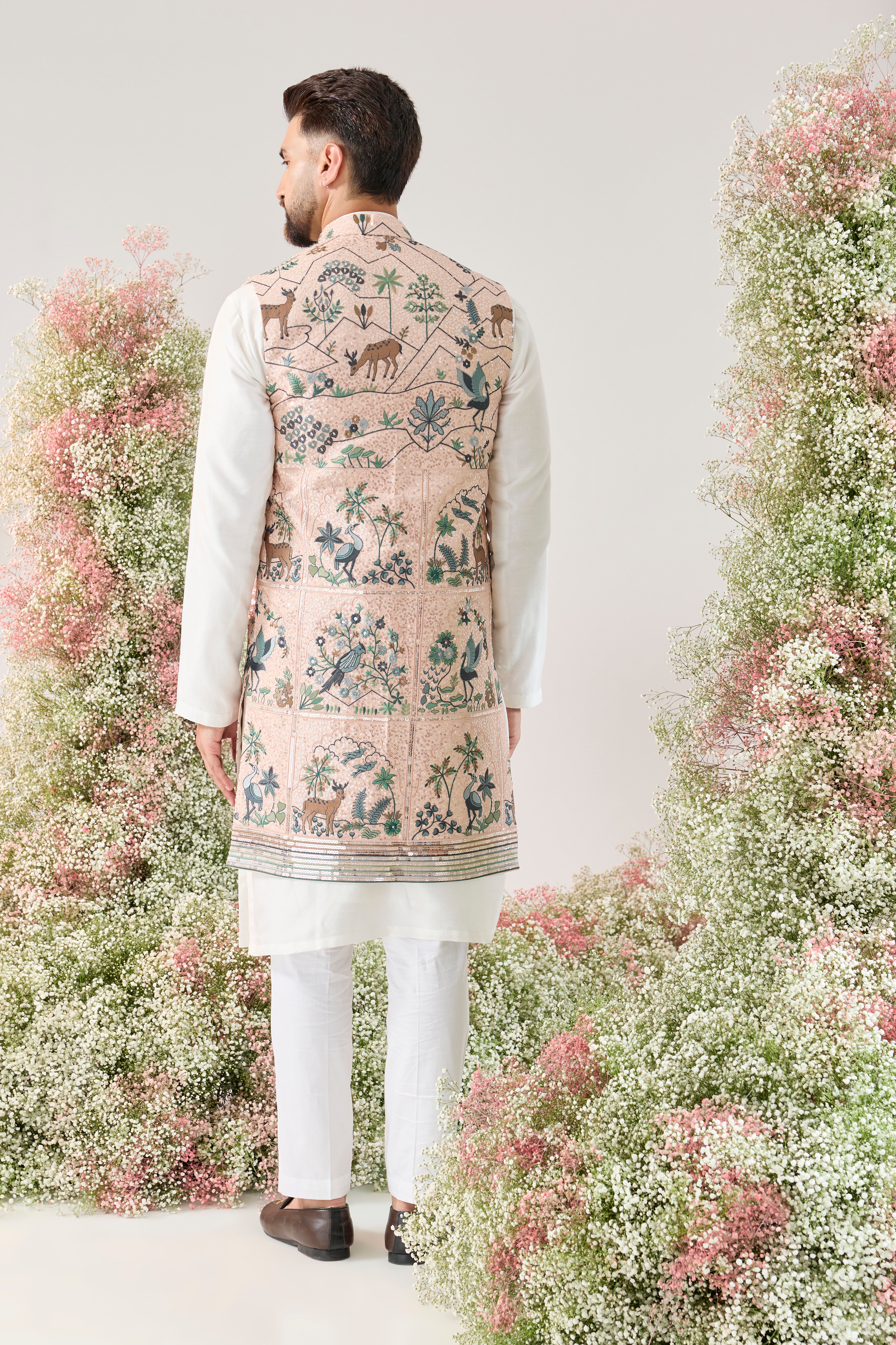 pink sequined long open jacket with an interplay of flora and fauna