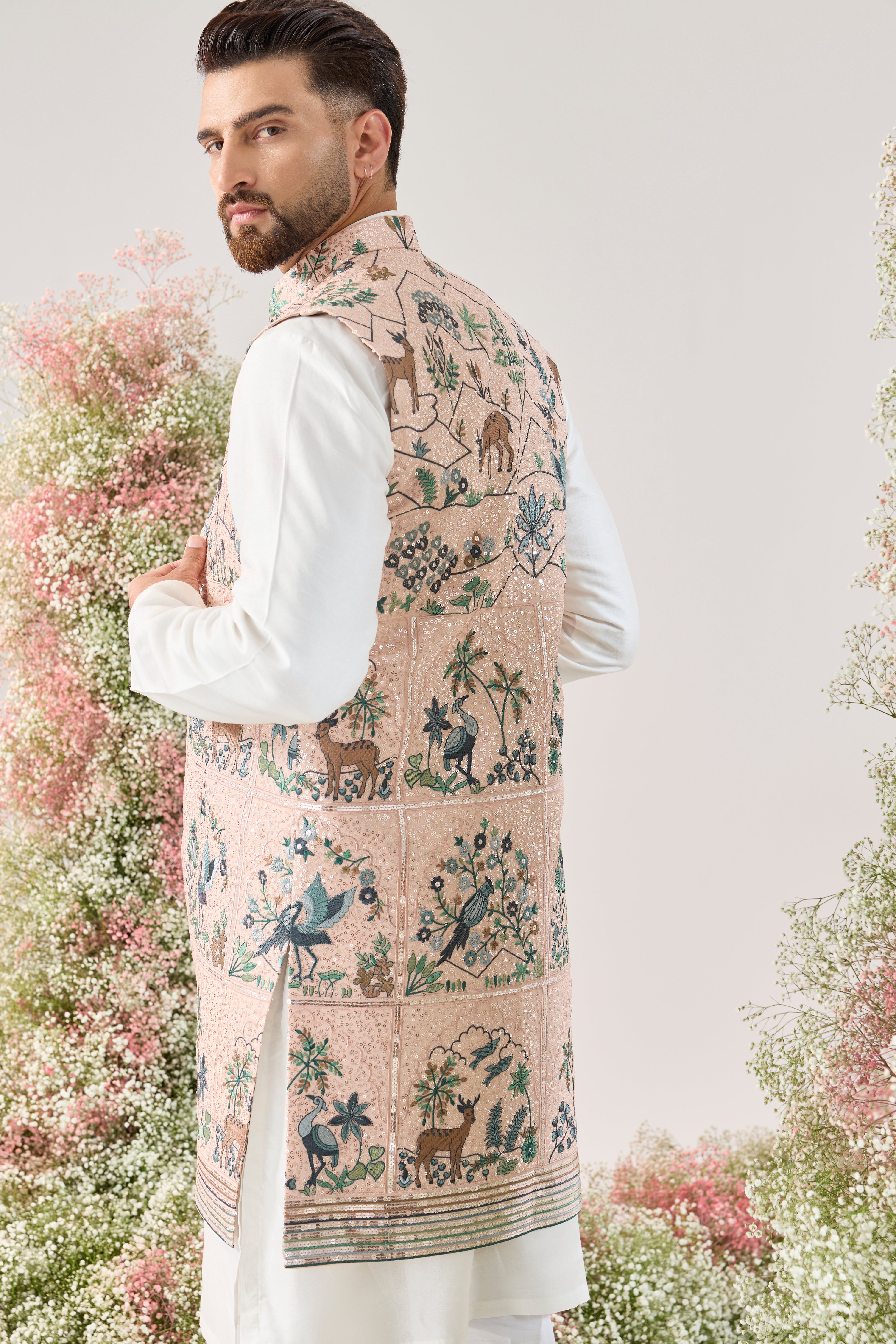 pink sequined long open jacket with an interplay of flora and fauna