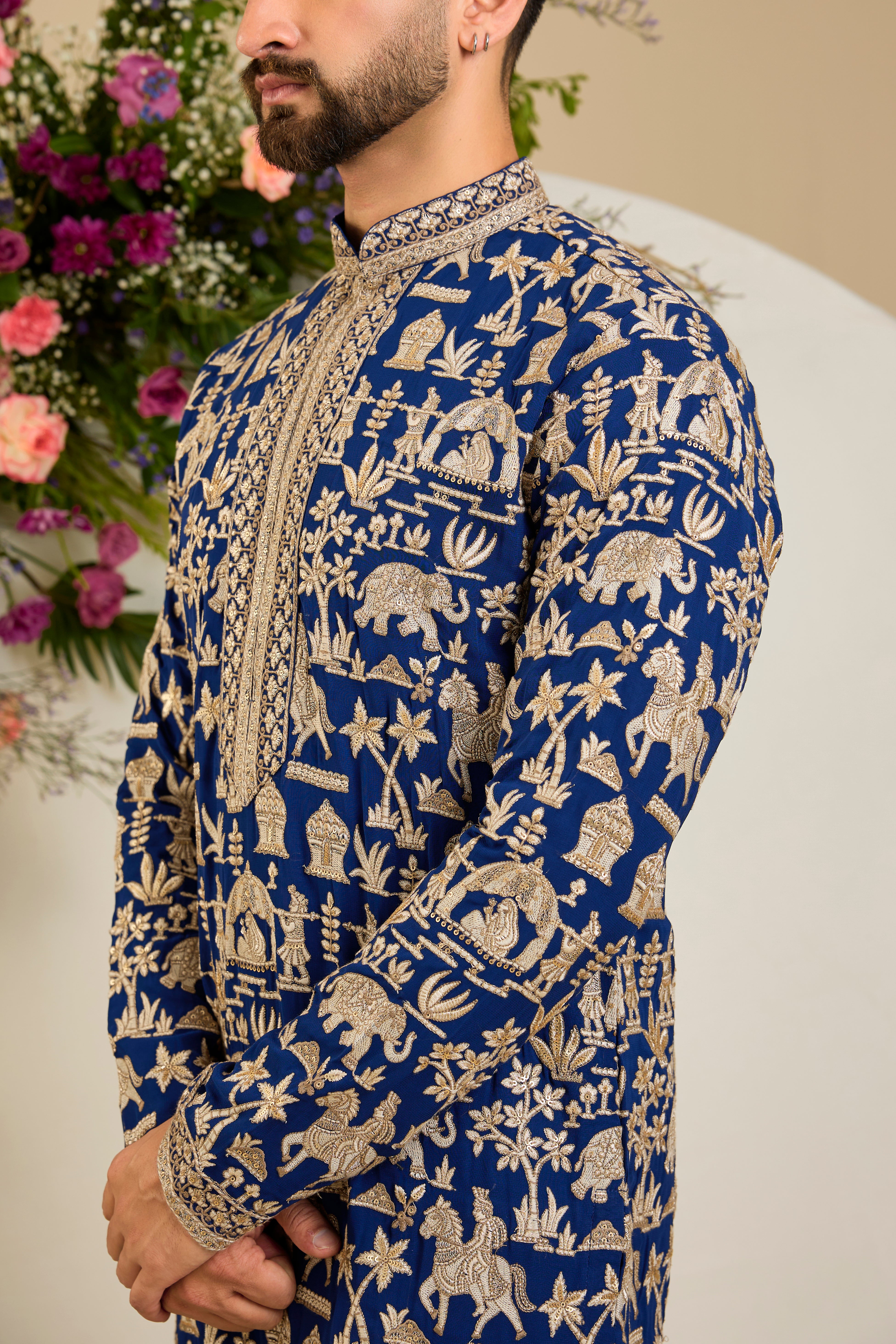 Royal blue kurta with Mughal-era embroidery, opulent zari work, sequins, and a refined neckline for timeless grandeur