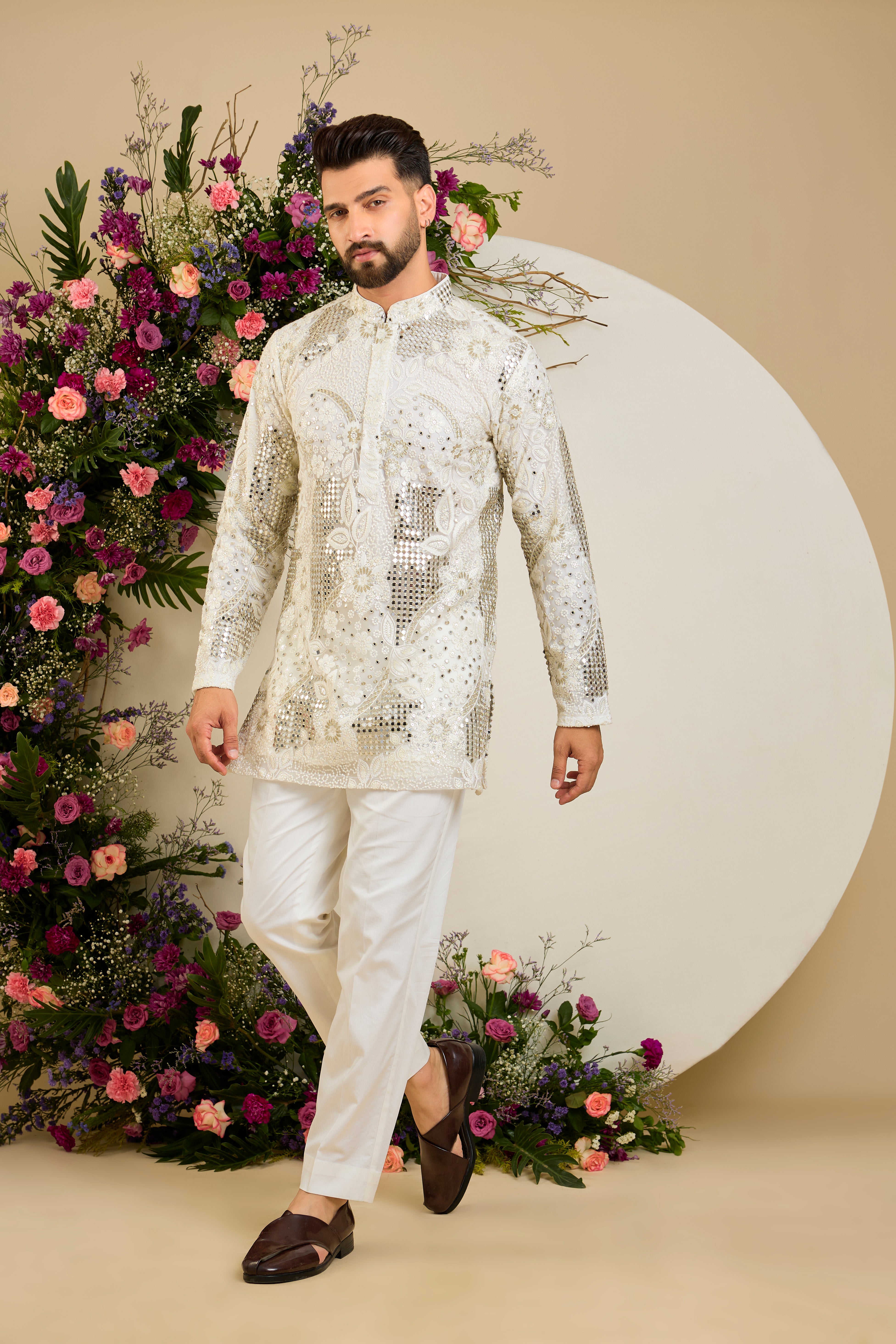 Ivory white mirror work kurta with intricate floral embroidery and refined zari detailing for timeless occasion elegance.