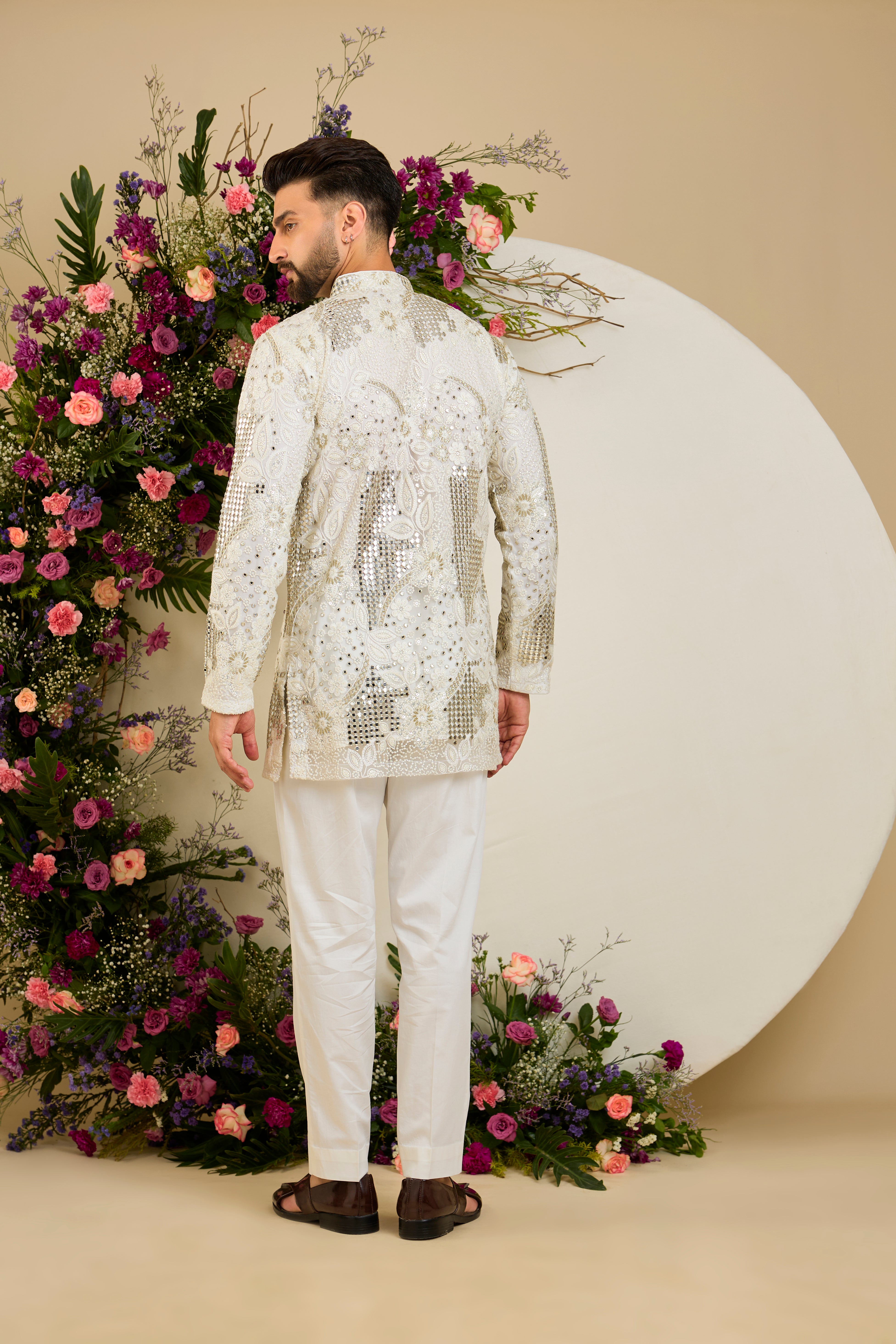 Ivory white mirror work kurta with intricate floral embroidery and refined zari detailing for timeless occasion elegance.