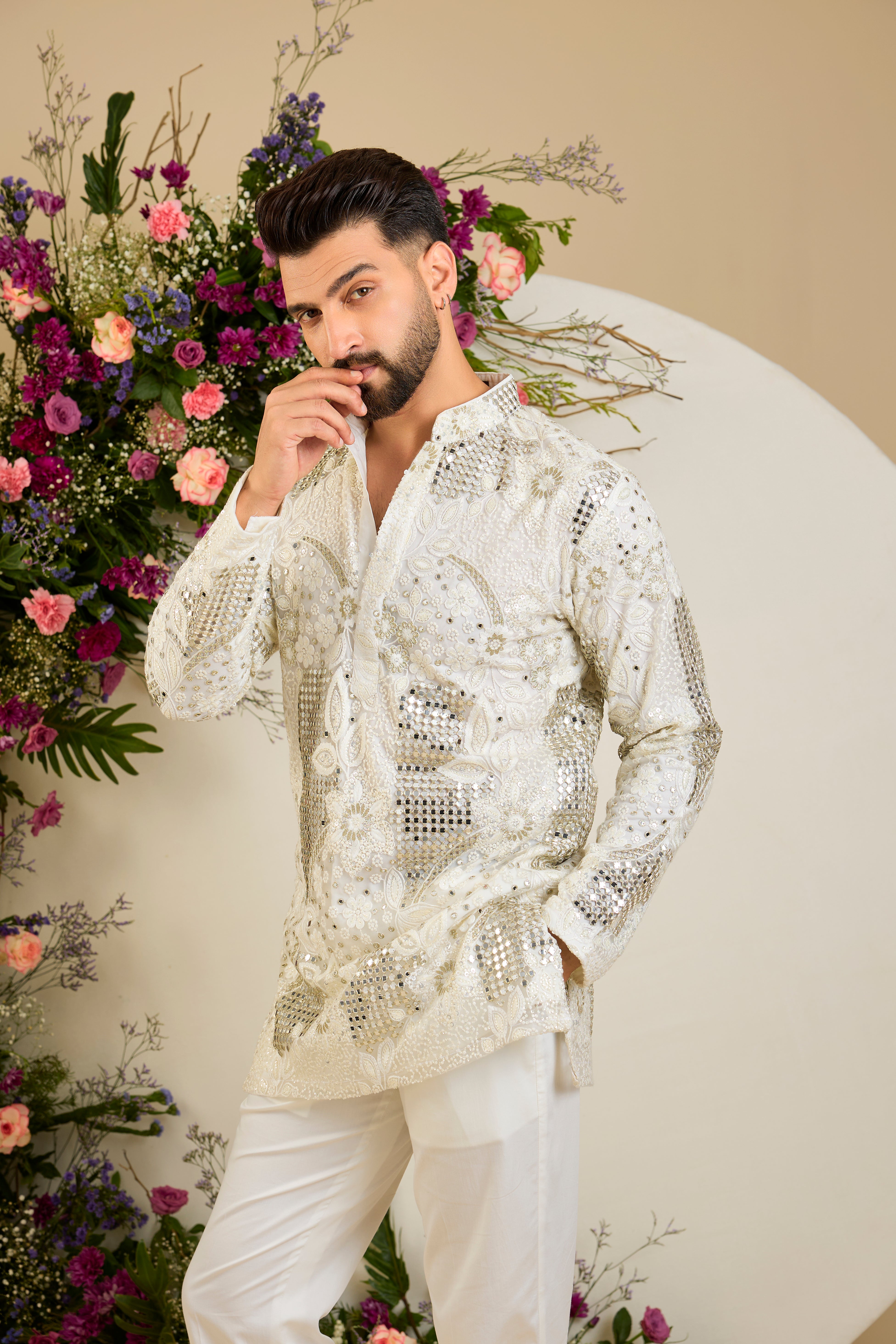 Ivory white mirror work kurta with intricate floral embroidery and refined zari detailing for timeless occasion elegance.