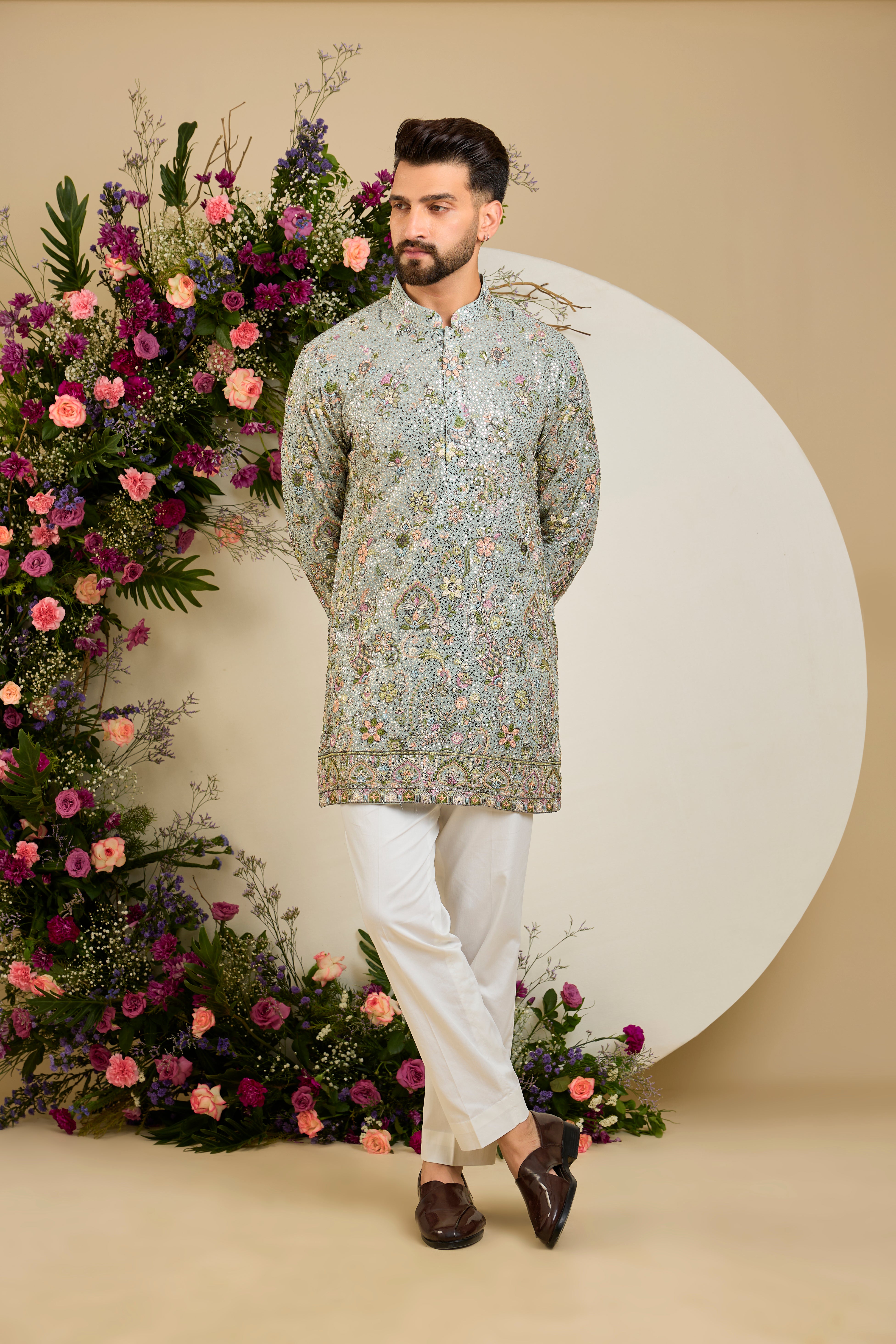Aqua blue fully sequined kurta with intricate multi-coloured thread embroidery, tailored for distinguished celebrations and timeless elegance.
