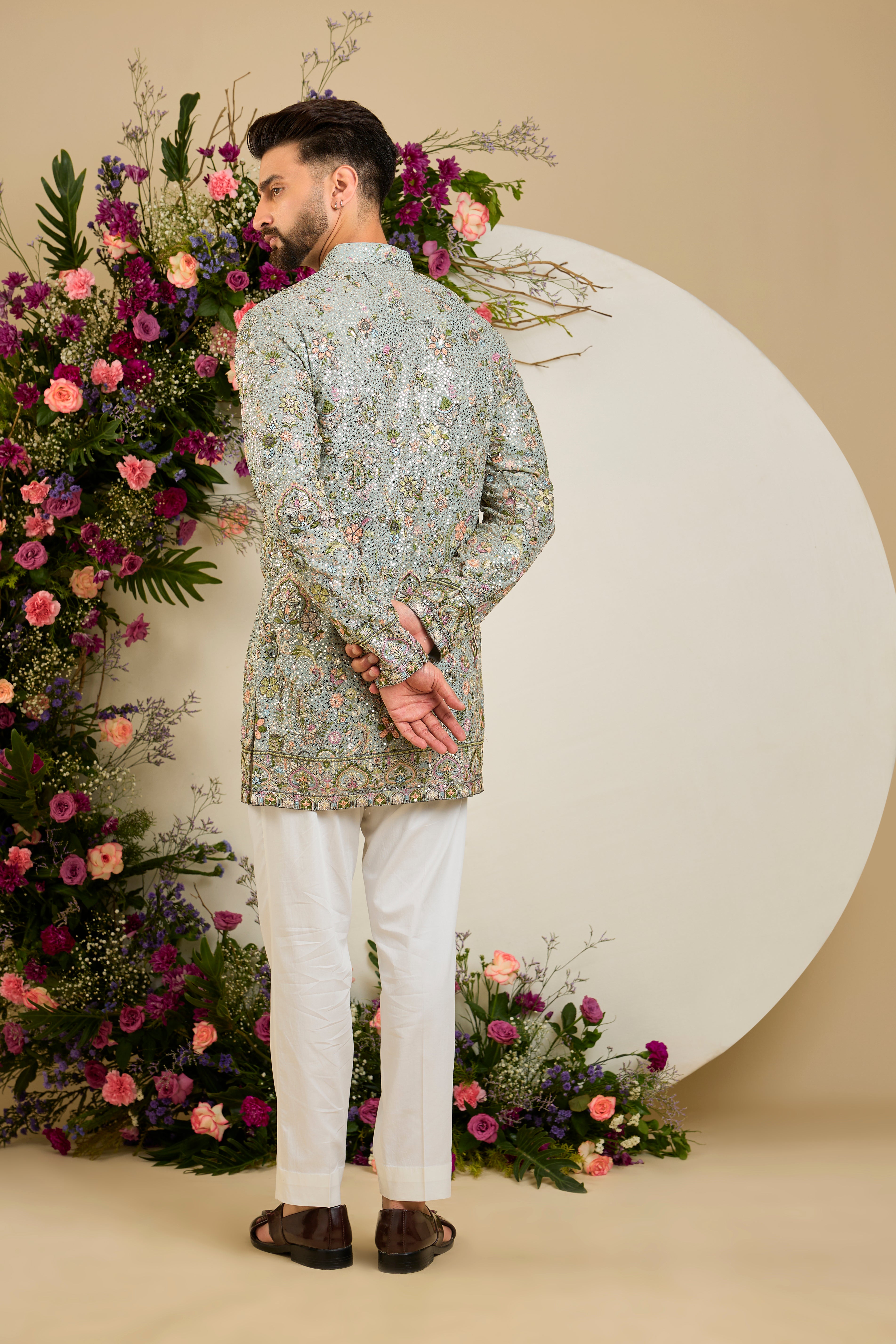 Aqua blue fully sequined kurta with intricate multi-coloured thread embroidery, tailored for distinguished celebrations and timeless elegance.
