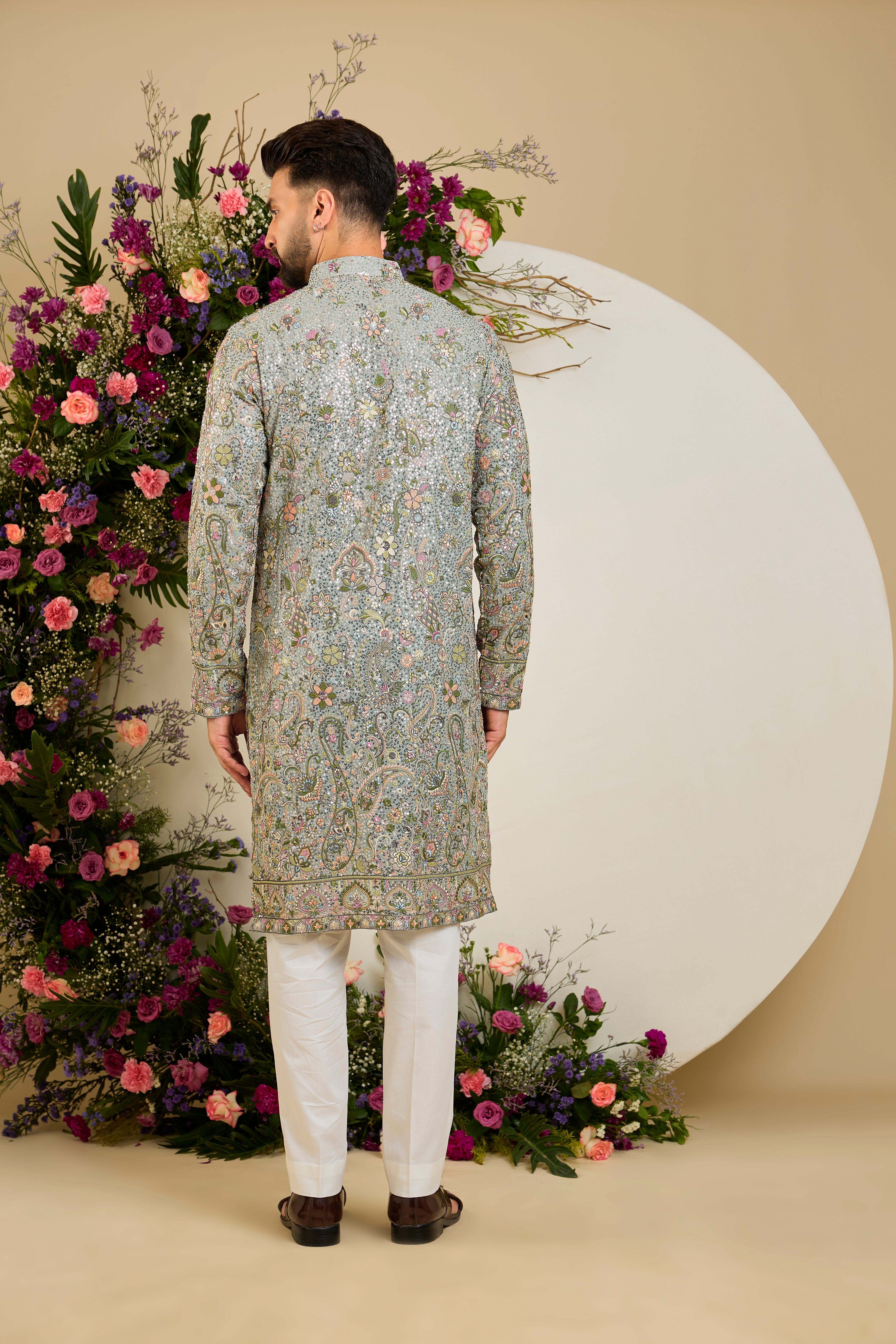 Heavy sequined  aqua blue shaded kurta with intricate multi-coloured thread embroidery, tailored for distinguished celebrations and timeless elegance.