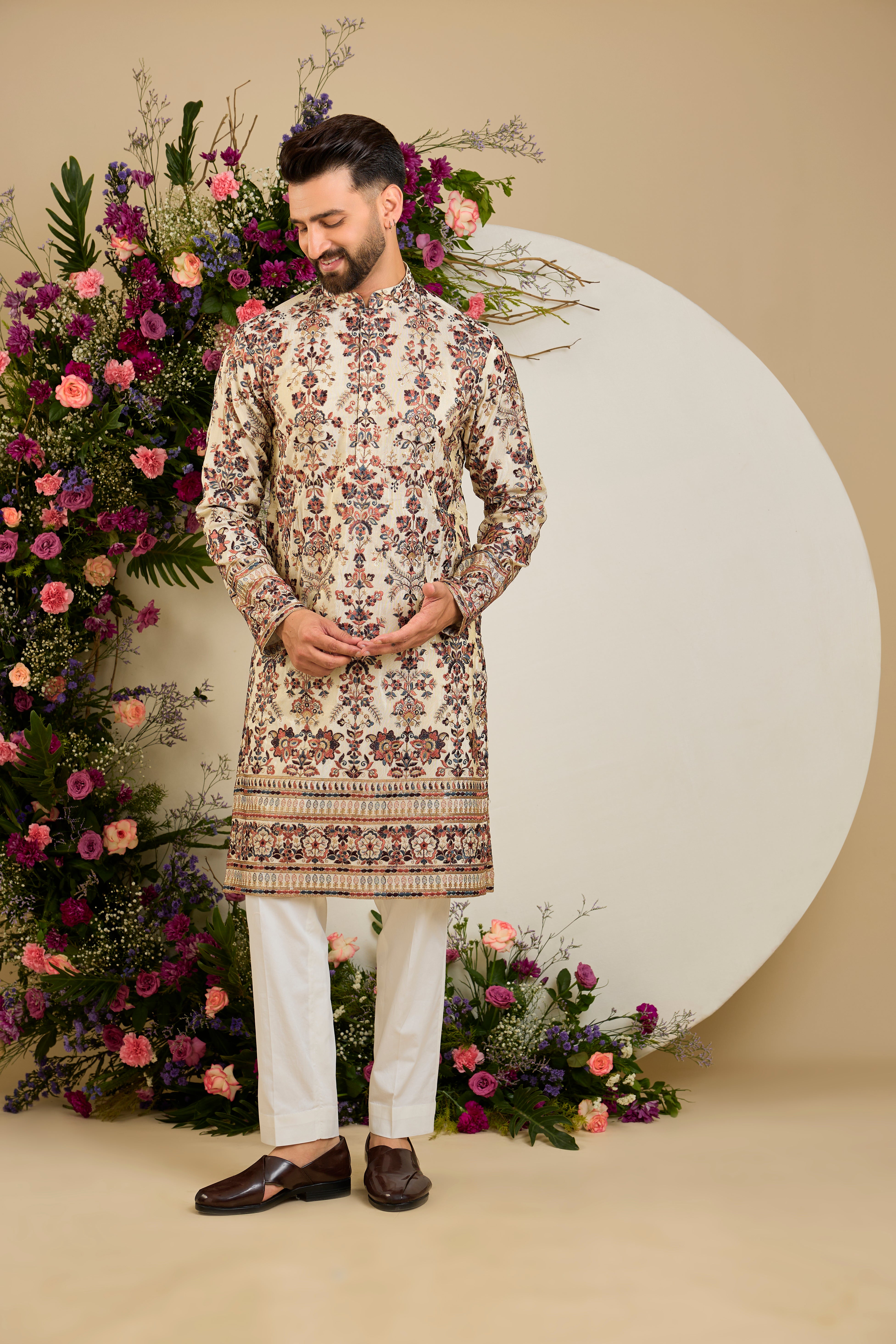 Golden tissue kurta with vibrant floral embroidery and delicate sequin detailing, crafted for refined and luxurious occasion dressing.