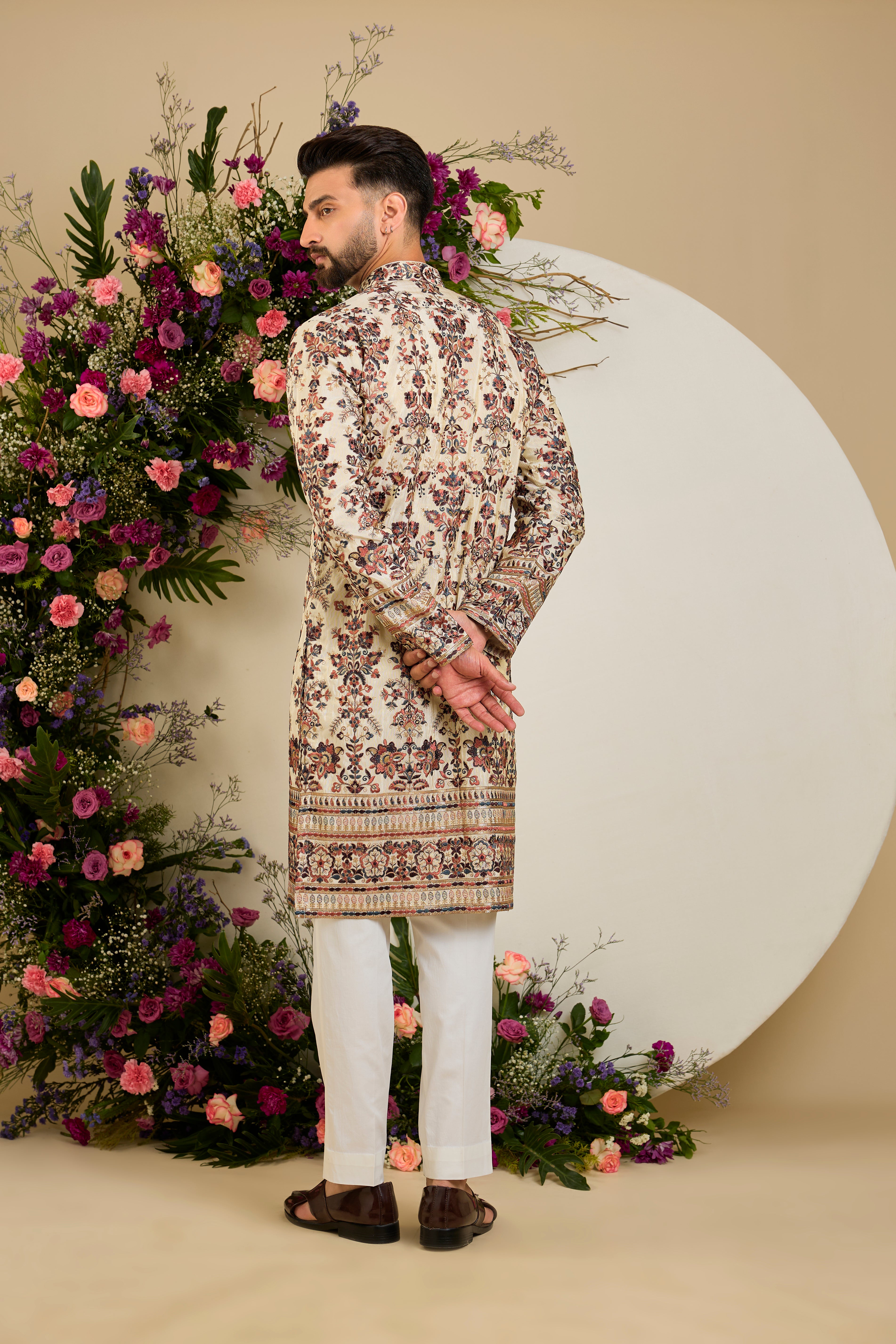 Golden tissue kurta with vibrant floral embroidery and delicate sequin detailing, crafted for refined and luxurious occasion dressing.