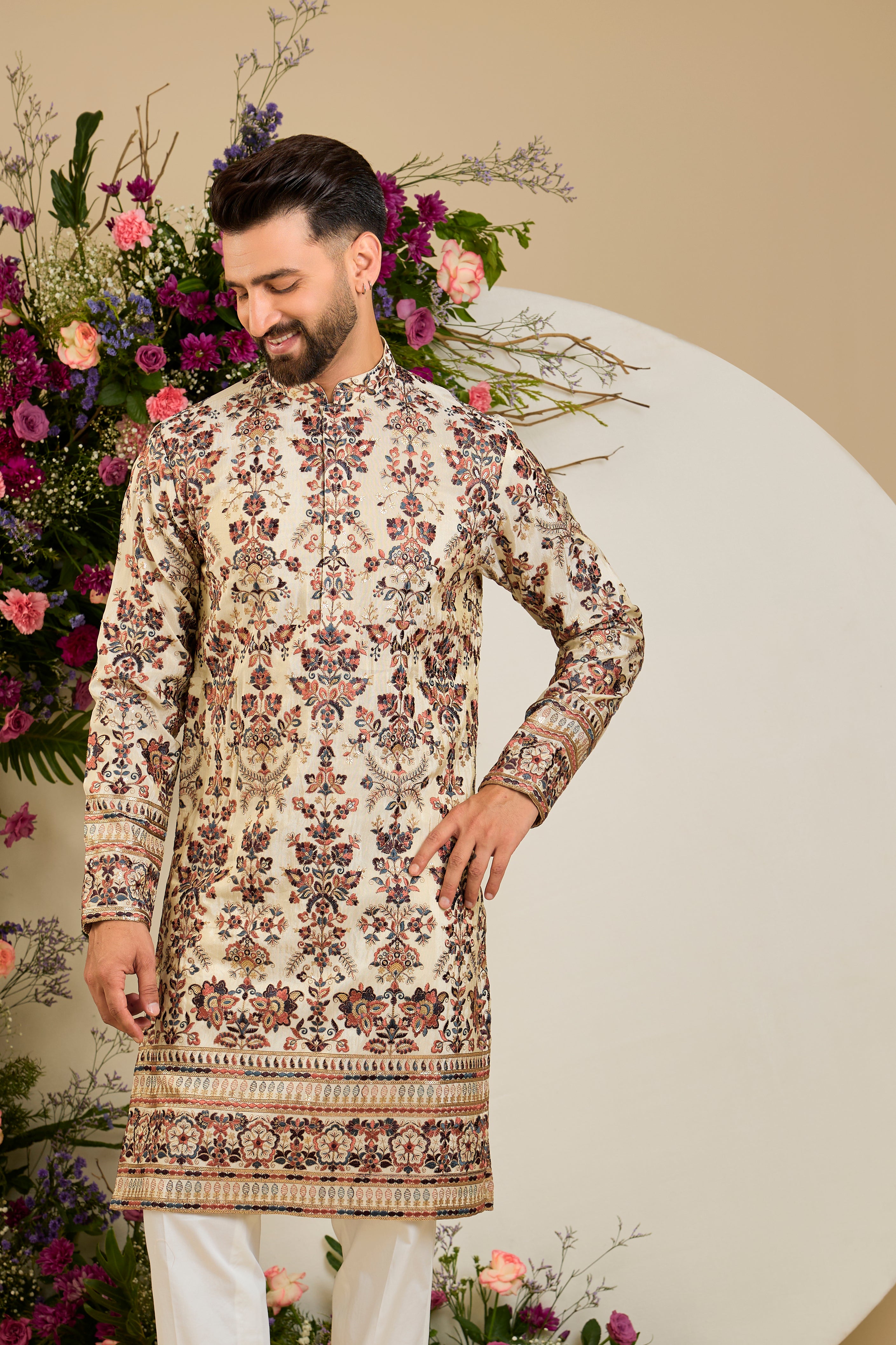 Golden tissue kurta with vibrant floral embroidery and delicate sequin detailing, crafted for refined and luxurious occasion dressing.