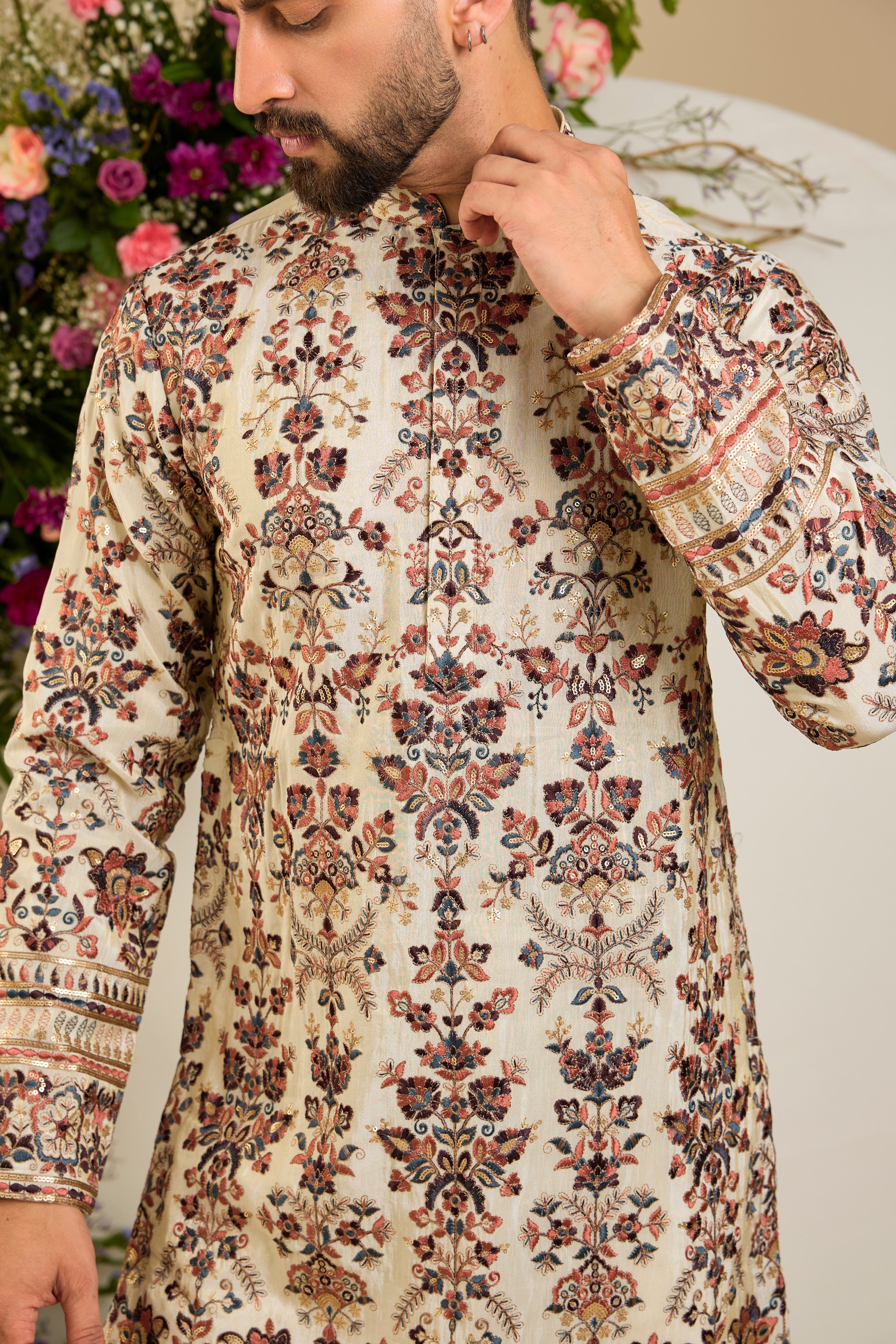 Golden tissue kurta with vibrant floral embroidery and delicate sequin detailing, crafted for refined and luxurious occasion dressing.