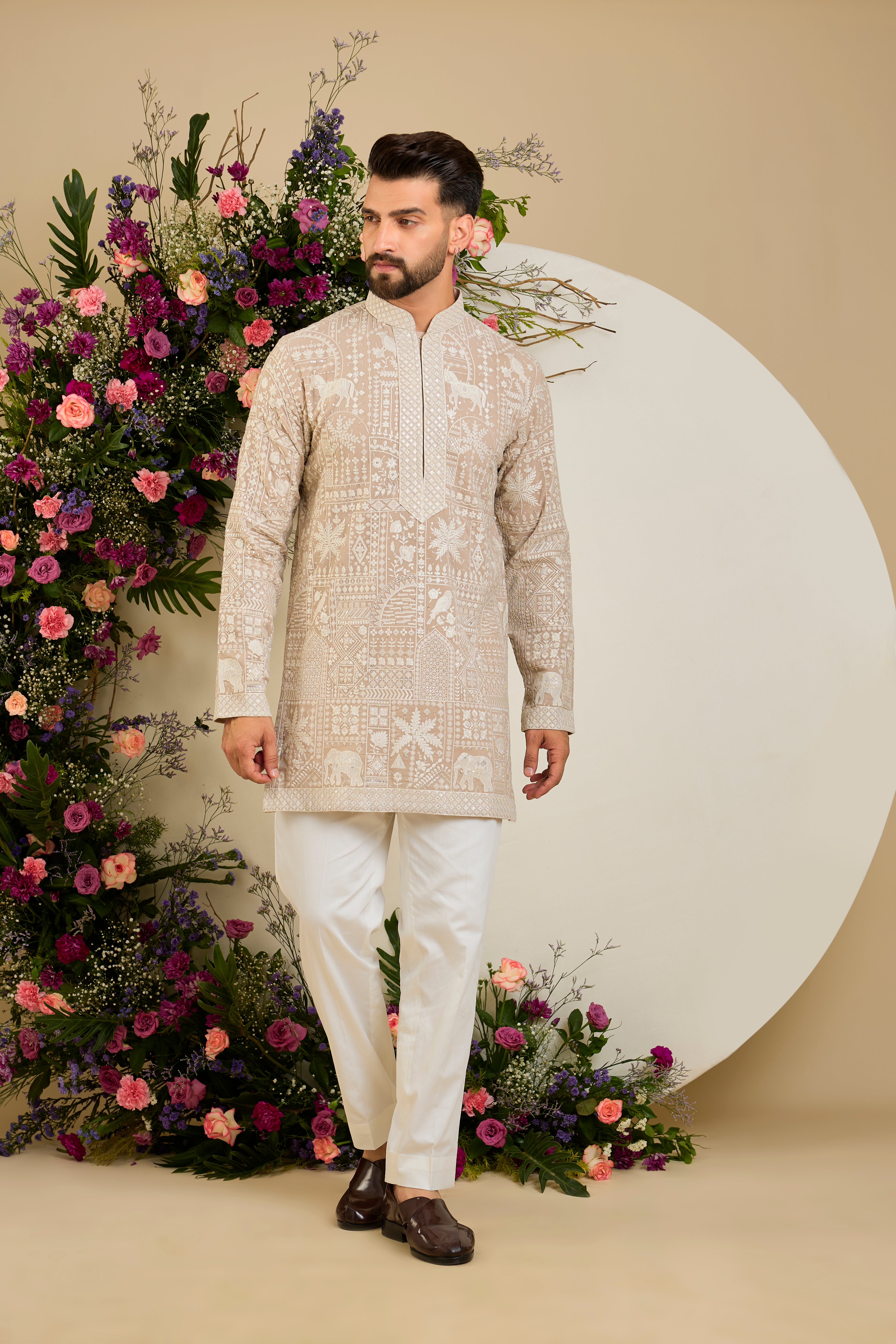 Light beige- mouse short  kurta with flora and fauna embroidery, an embellished neckline, ivory threadwork, and delicate sequin detailing.