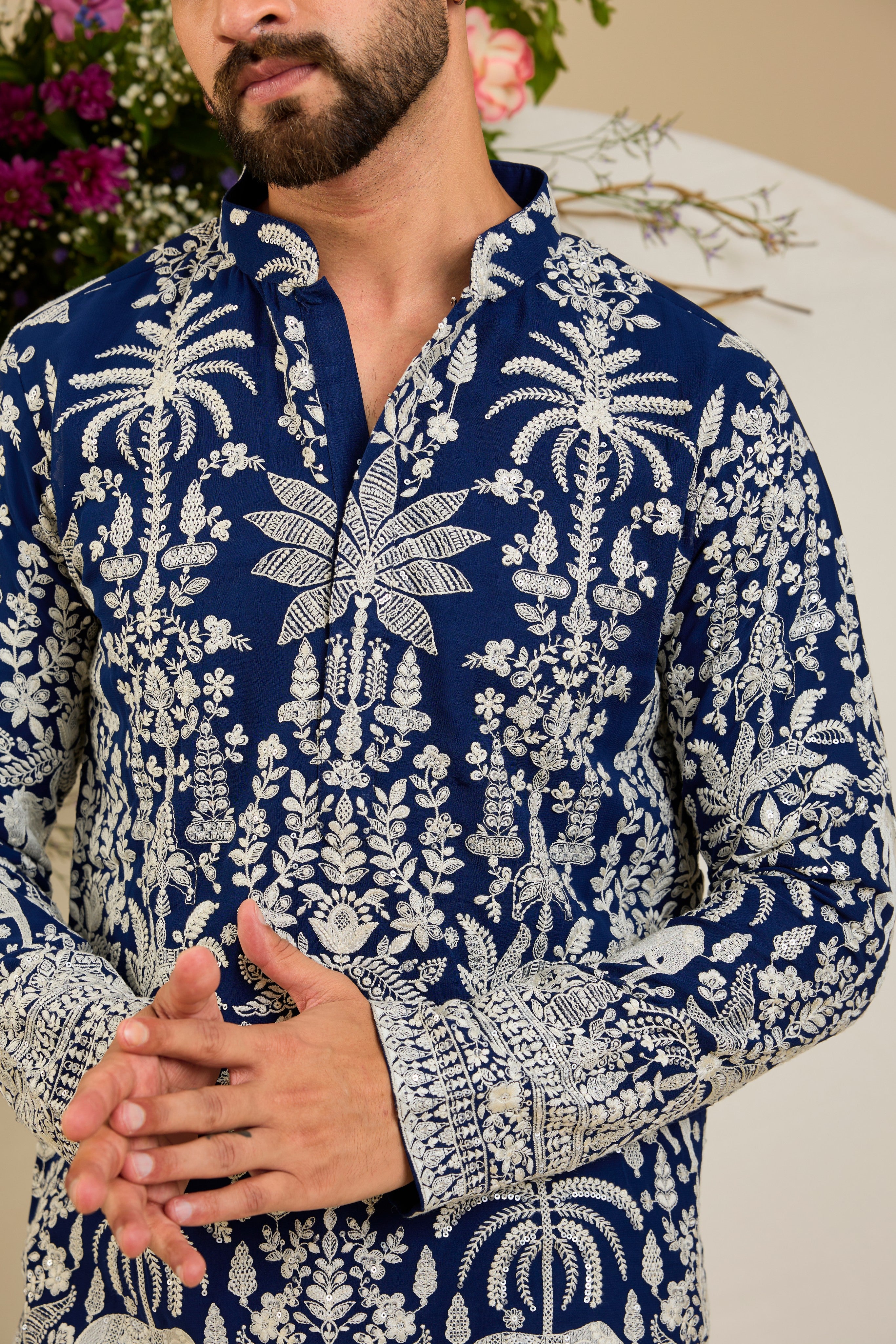 Royal blue short kurta with tropical flora and fauna embroidery, ivory threadwork, and delicate sequin detailing for refined occasion wear.