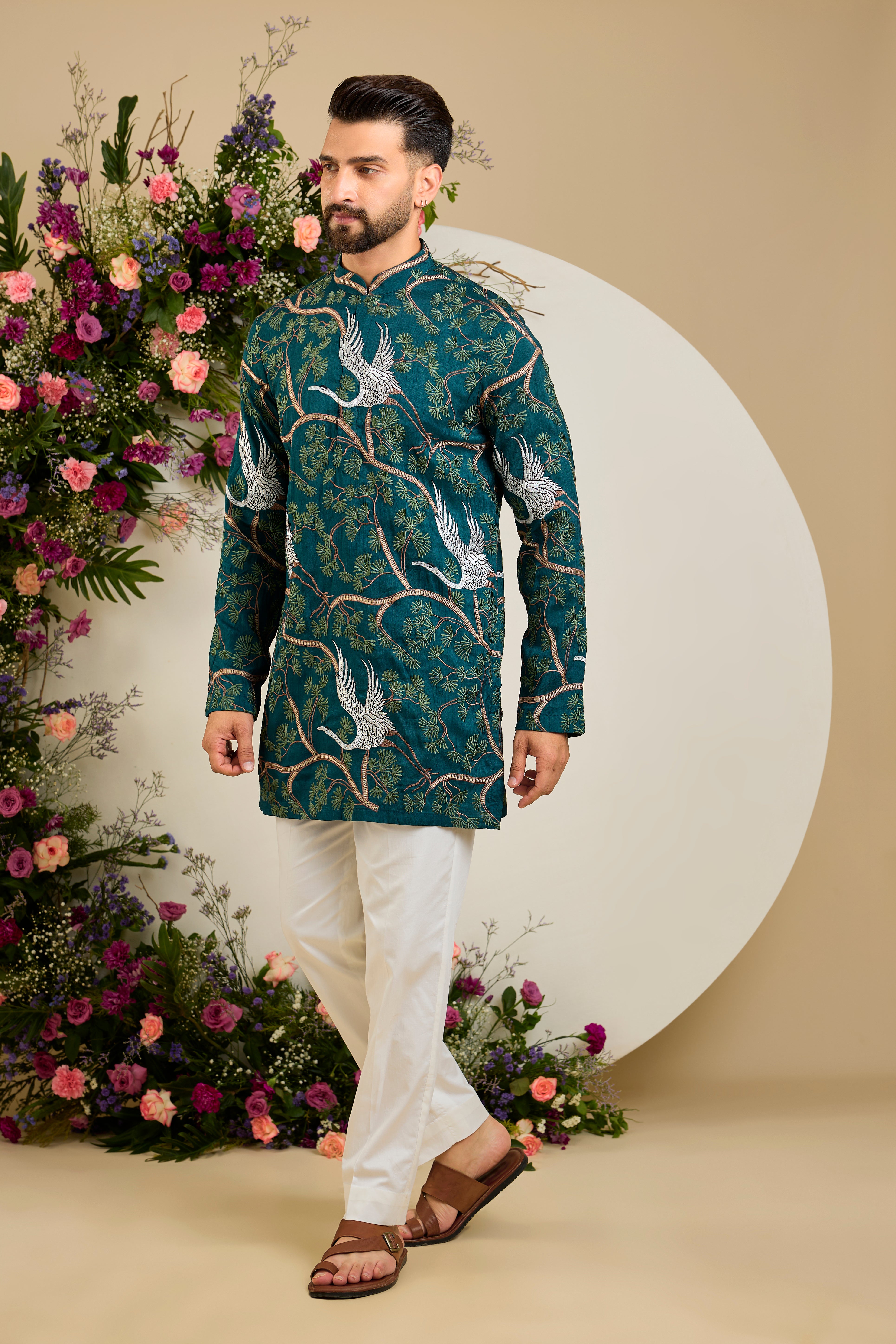 Green short kurta with a tropical backdrop, graceful flamingo motifs, intricate threadwork, and delicate sequin embellishments.