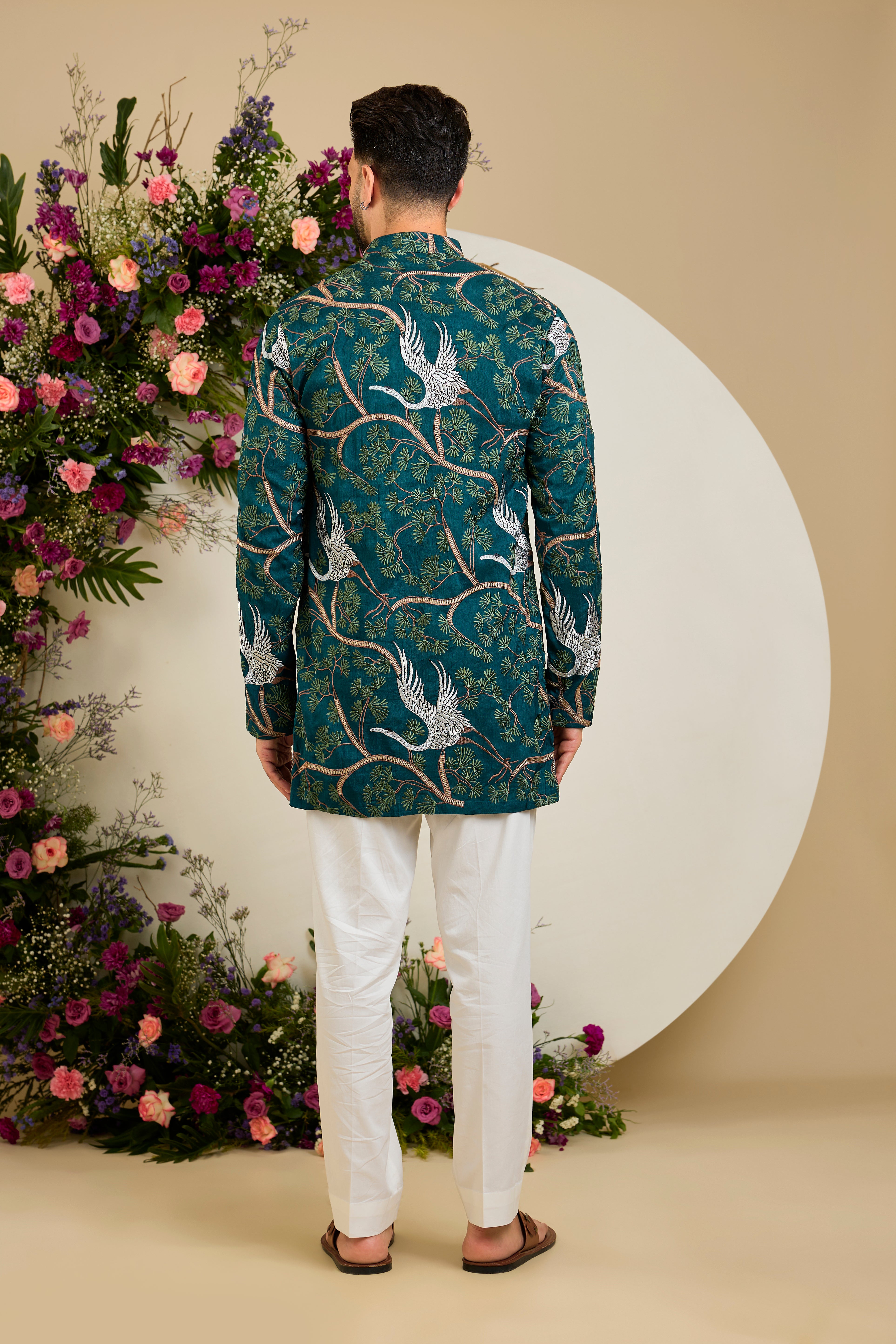 Green short kurta with a tropical backdrop, graceful flamingo motifs, intricate threadwork, and delicate sequin embellishments.