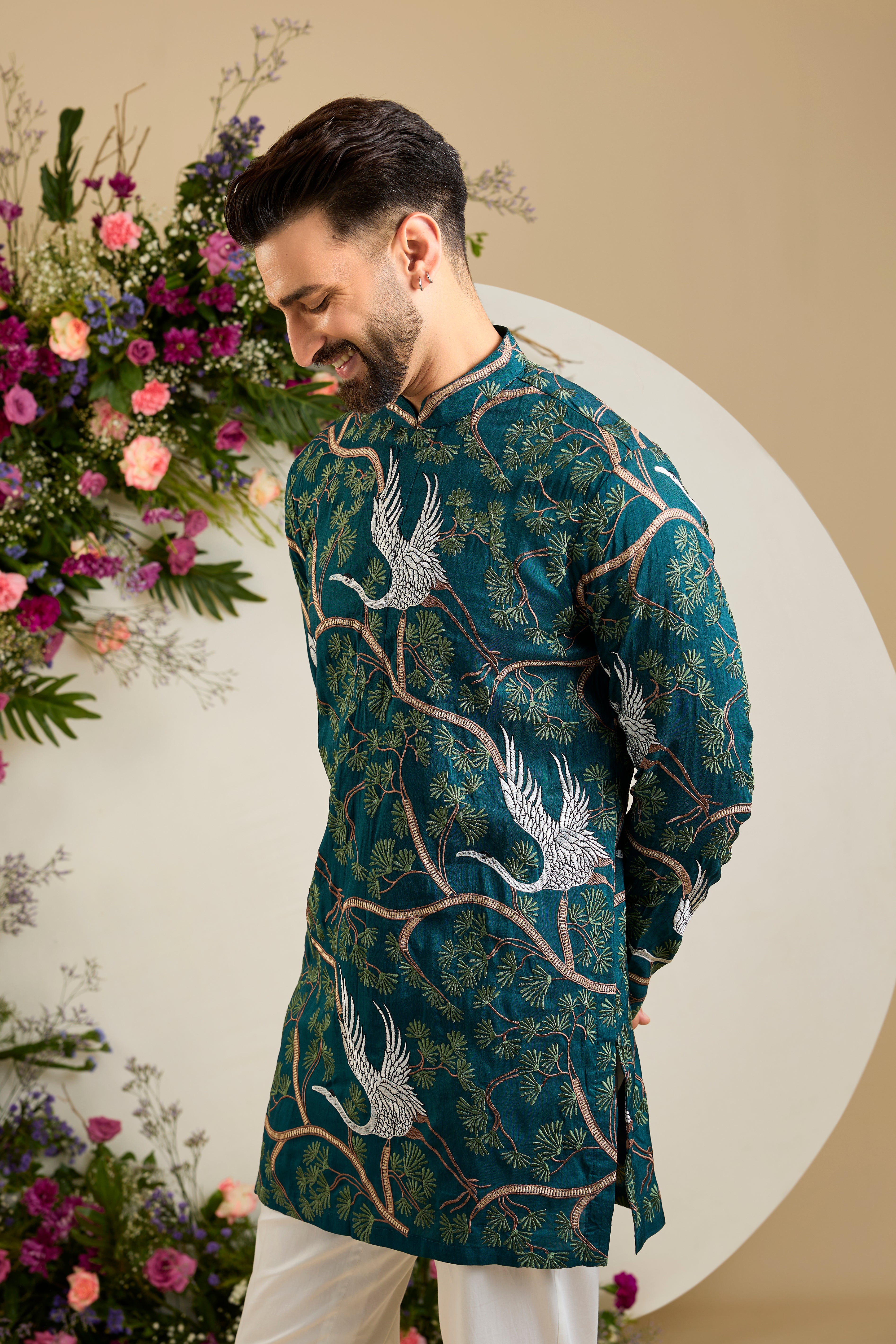 Green short kurta with a tropical backdrop, graceful flamingo motifs, intricate threadwork, and delicate sequin embellishments.