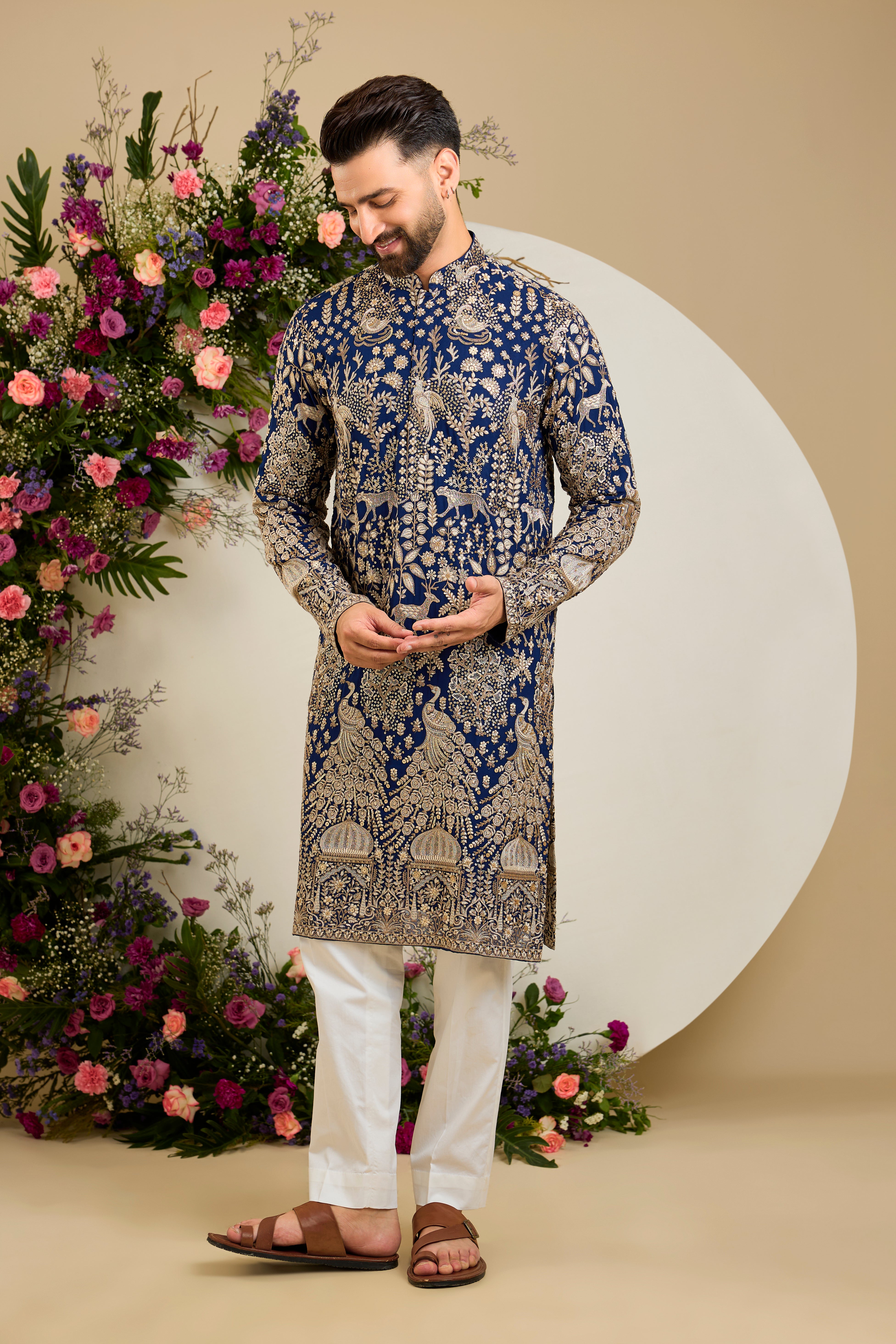 Royal blue heritage   kurta with Mughal domes, peacocks, lions, heavy zari embroidery, and refined sequin detailing.